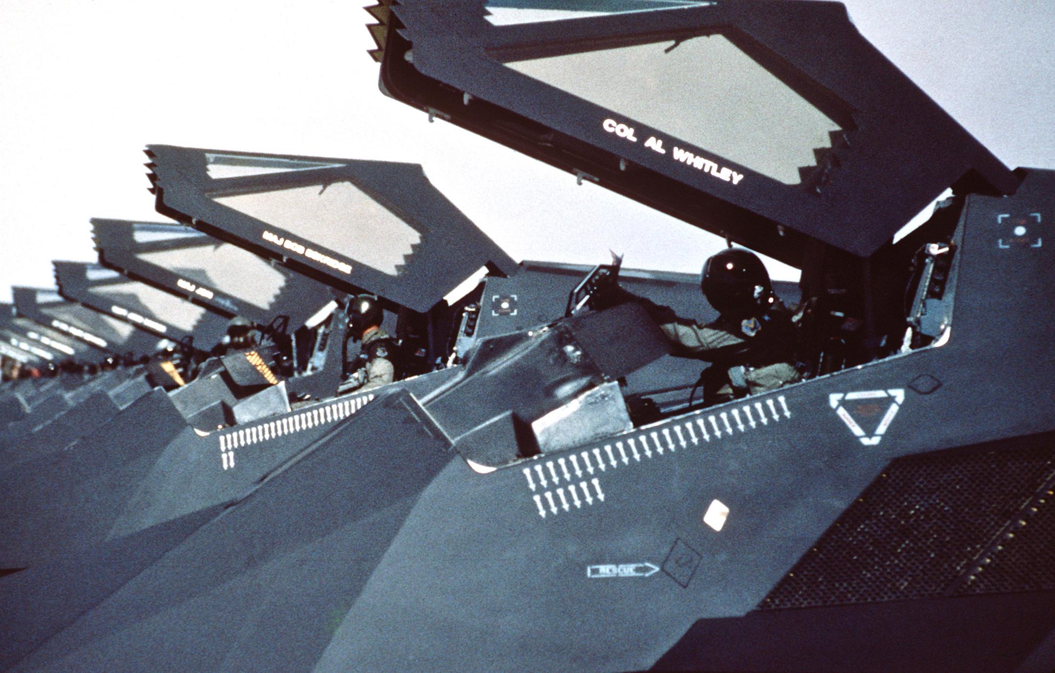 F117 Nighthawks lined up on the flight line with canopies raised