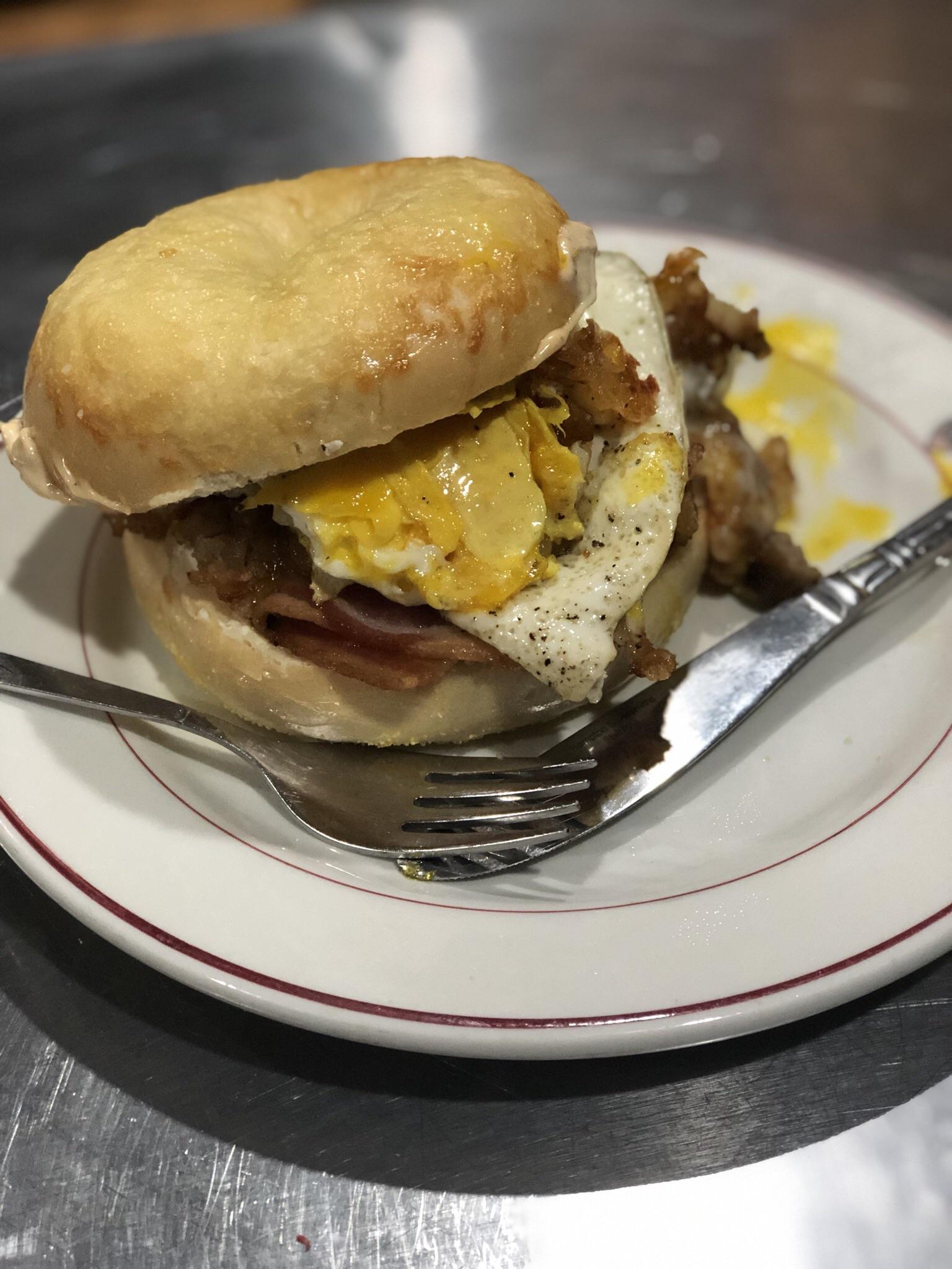 Asiago Cheese Bagel with Bacon, Sausage, Hash Browns, and an Egg. r