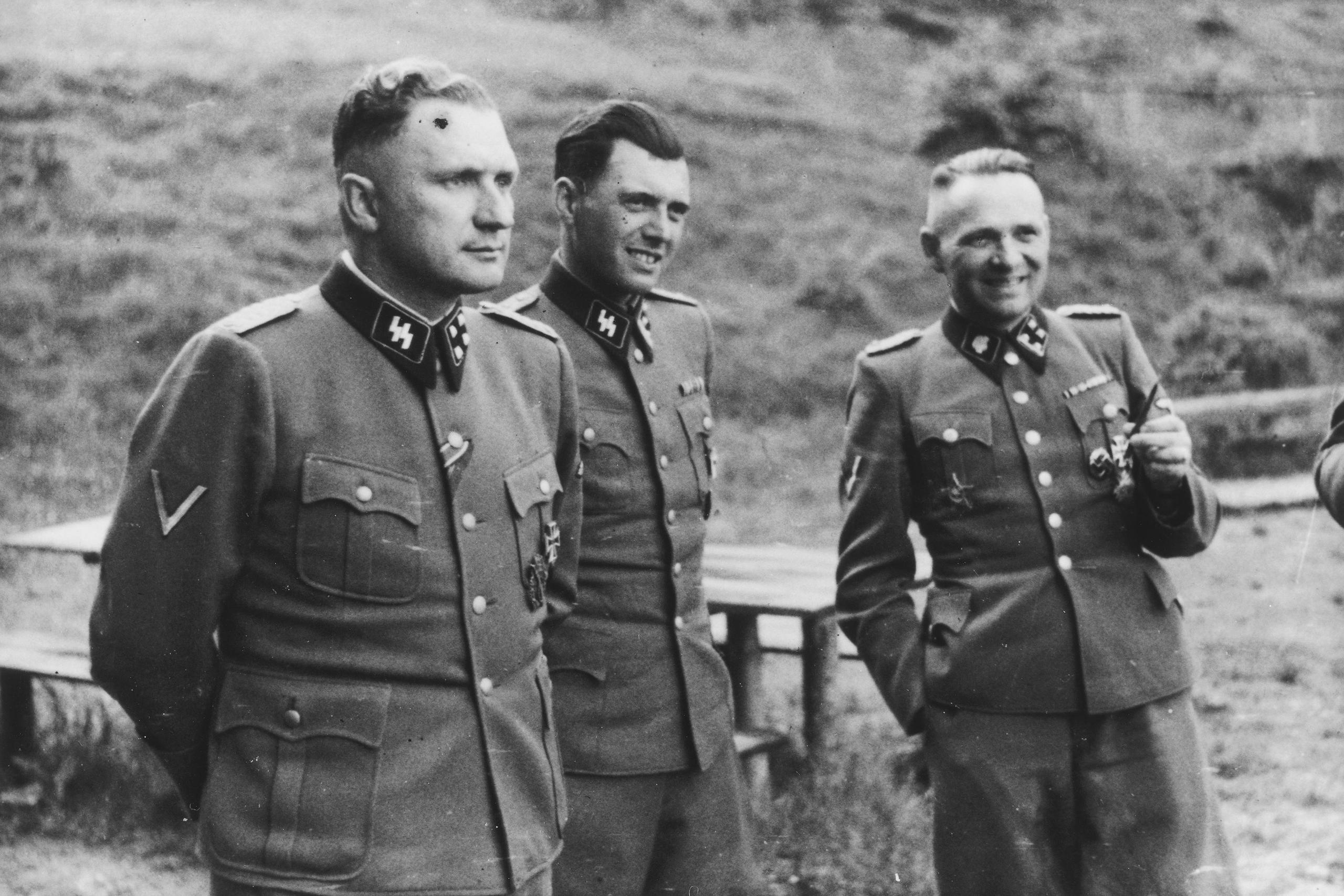 Richard Baer, Dr. Josef Mengele and Rudolf Hoess on the grounds of the