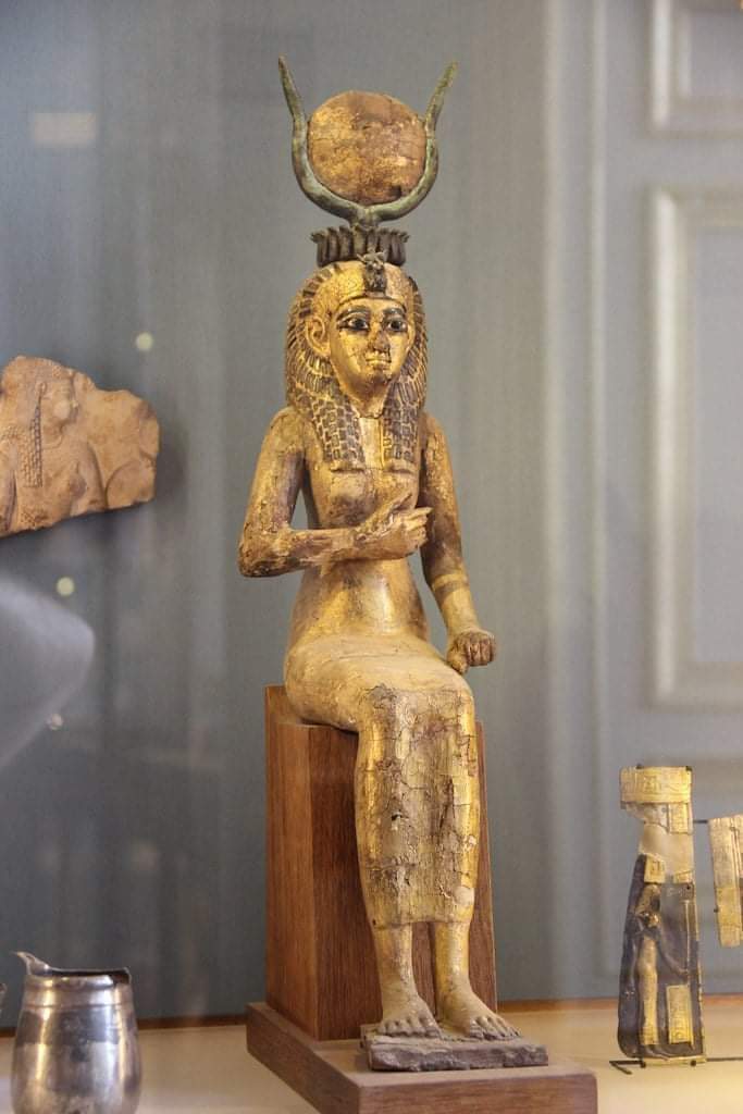 Statue of the Egyptian goddess Isis. Made of tamarisk wood, covered in bronze and glass. r