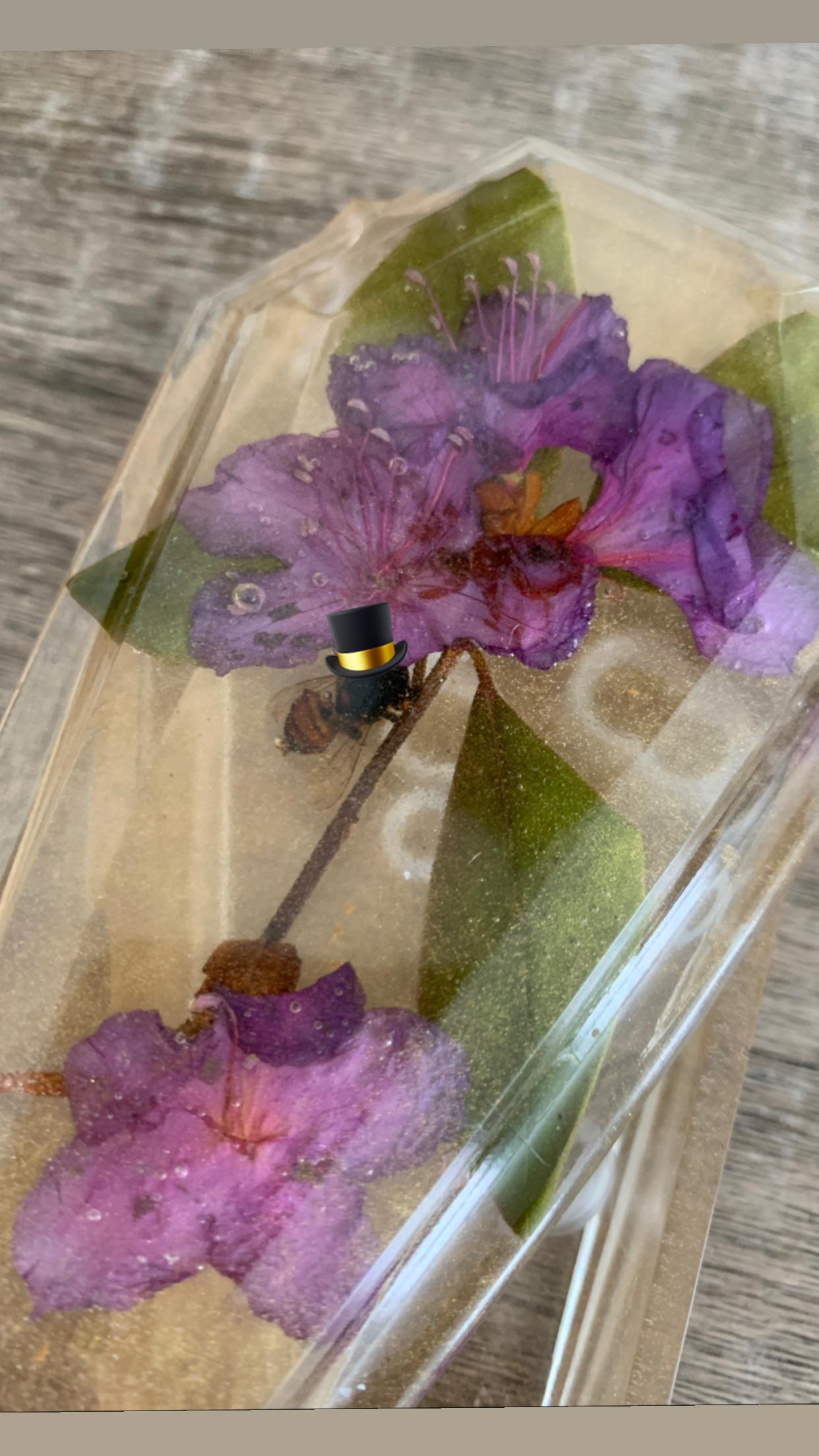 Little fancy guy trapped in resin with a flower courtesy of my