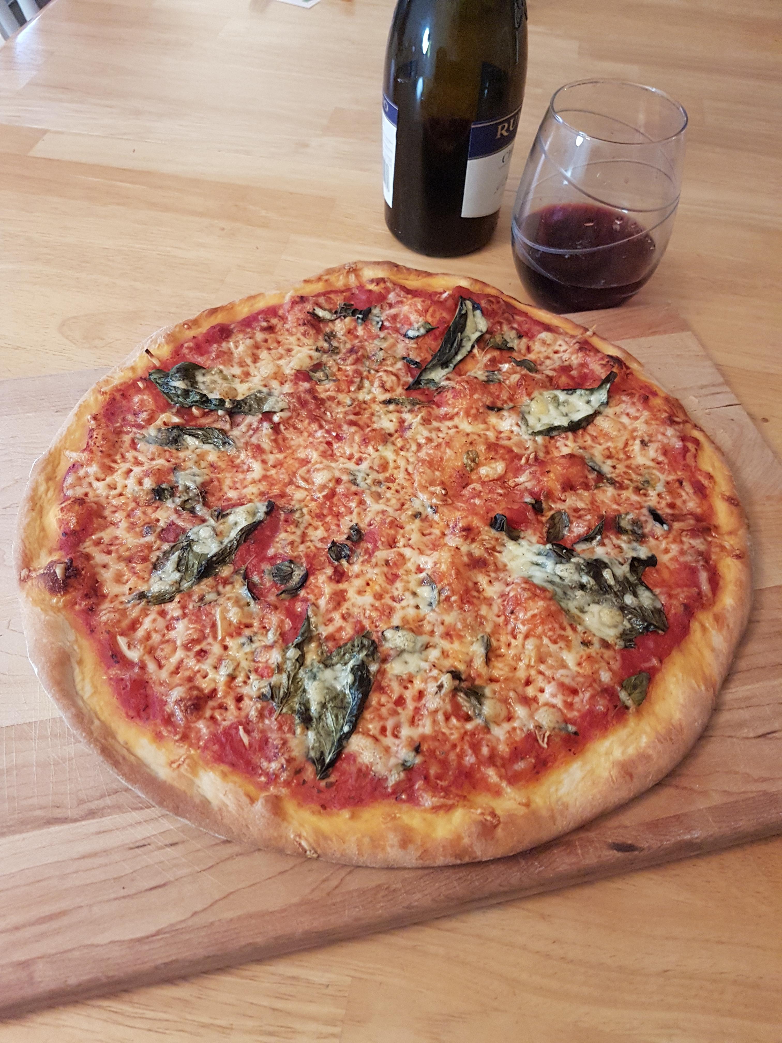 A simple pizza. Fresh basil, oregano, garlic. [Homemade] r/food