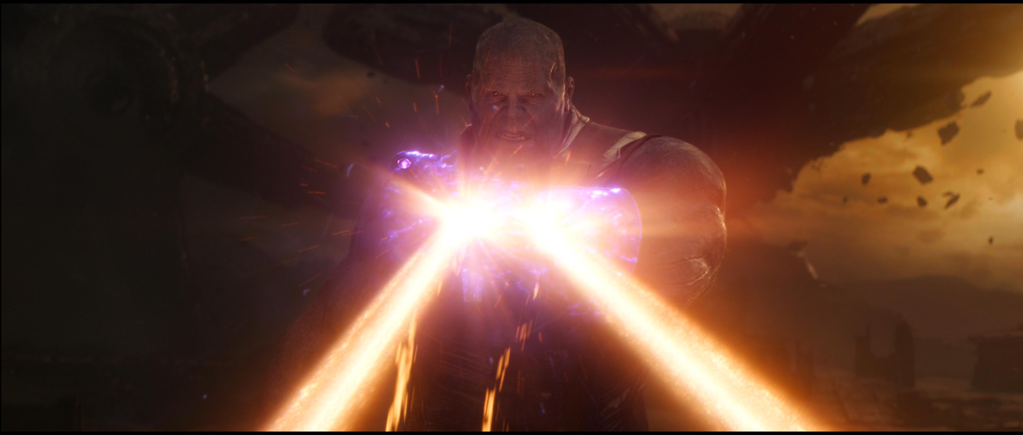 Thanos uses the Power Stone to absorb Iron Man's repulsor blasts. r