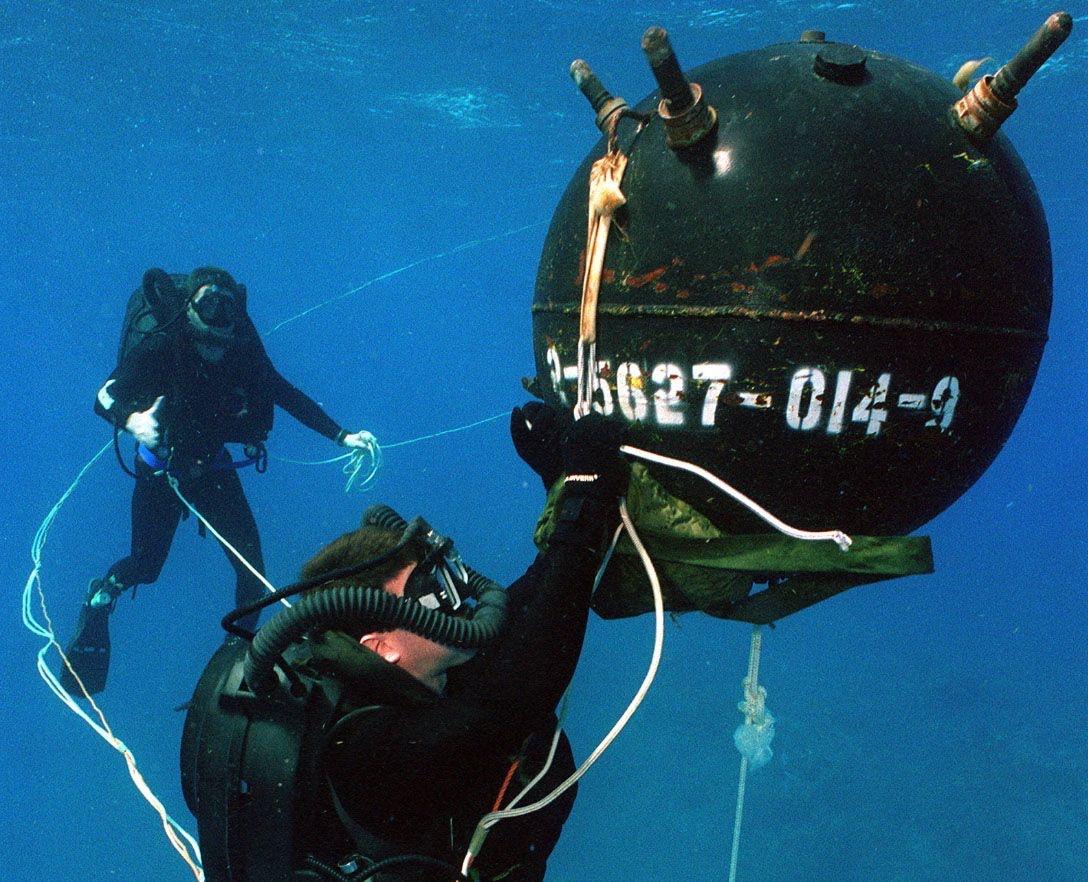 US Navy EOD performing Render Safe procedure on a sea mine. [1088x882