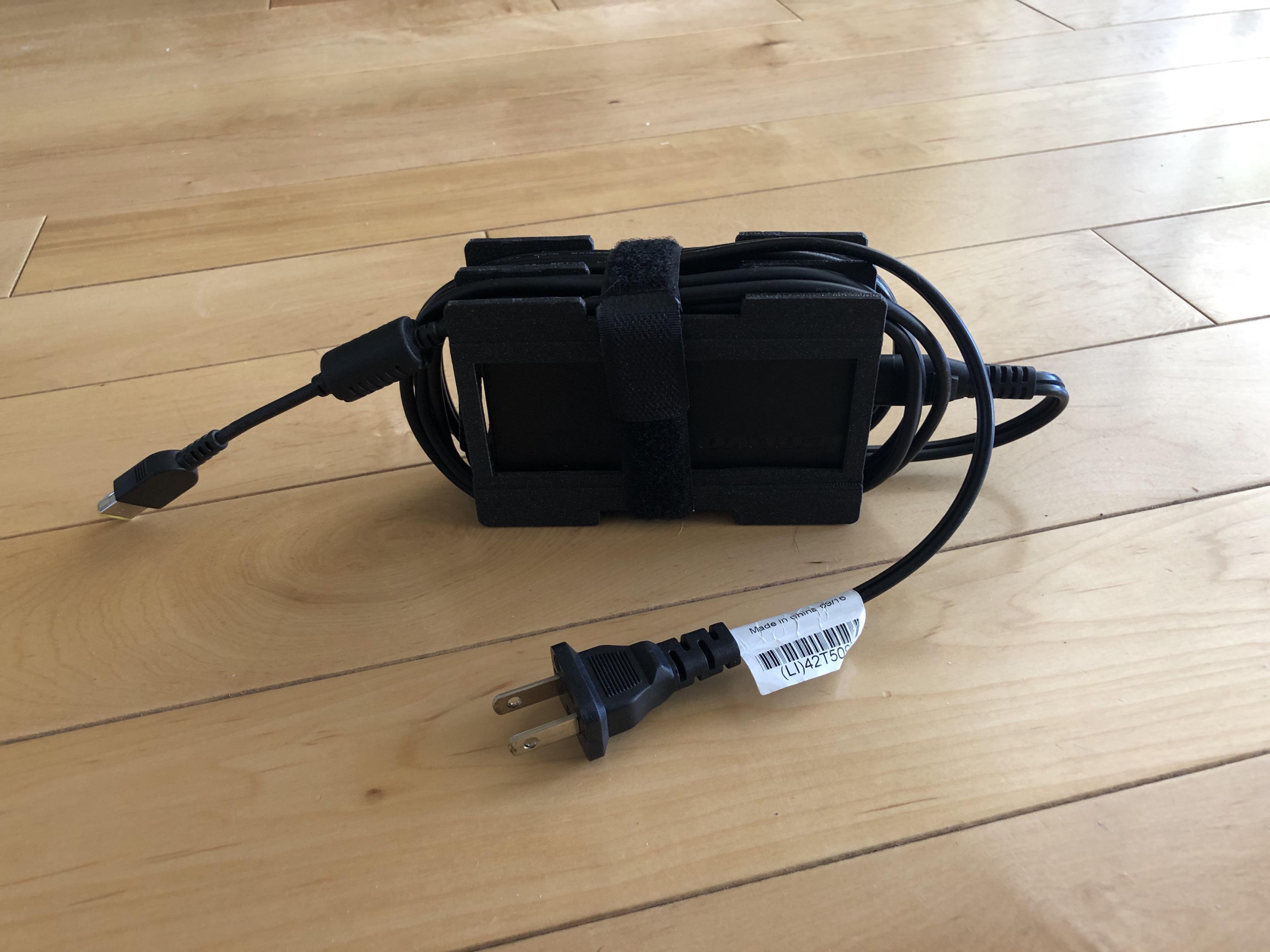 An accessory for the Lenovo laptop charger to wrap up the cables neatly