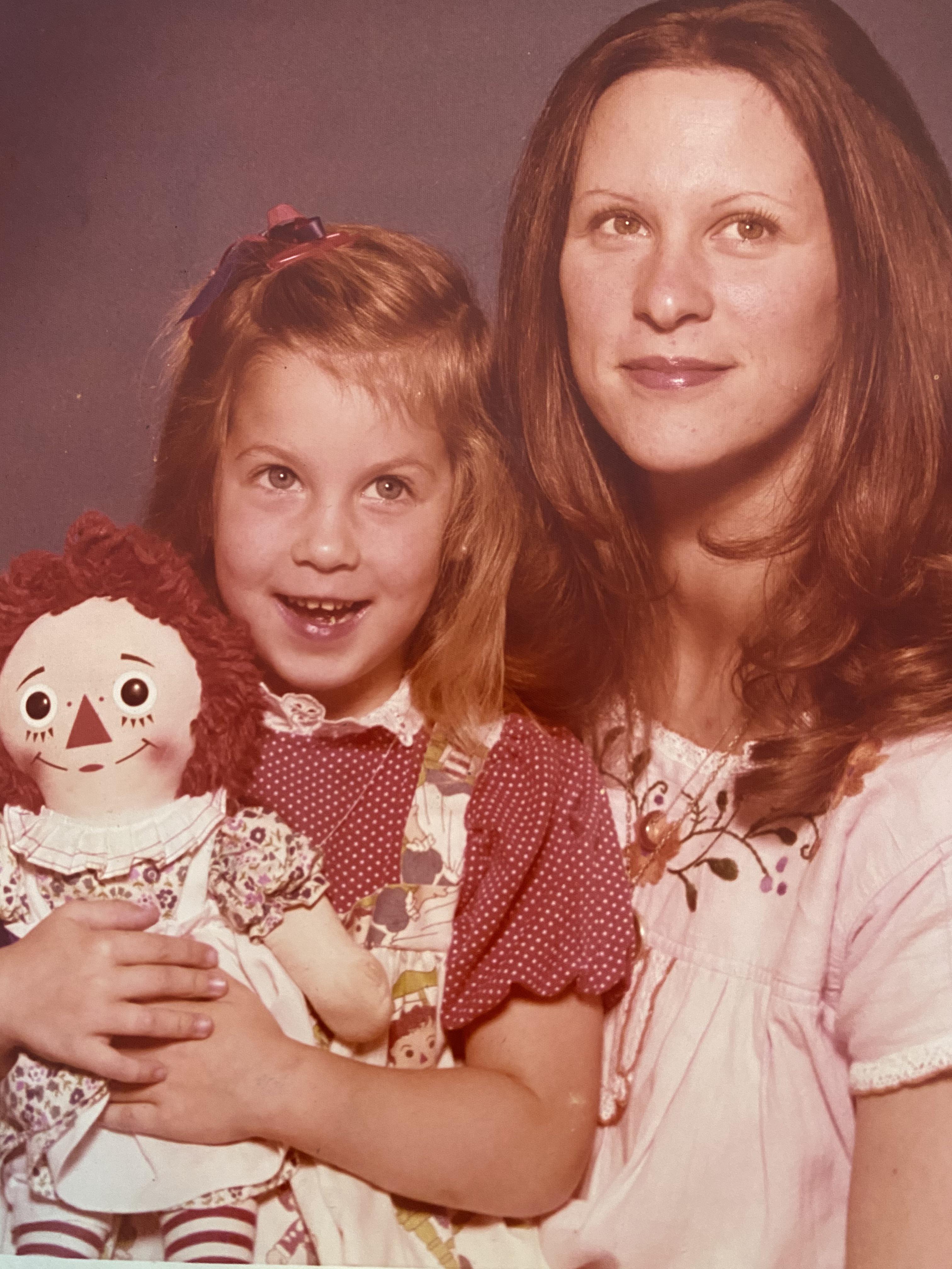 1975 family portrait ft. Raggedy Ann taken at Kmart portrait studio
