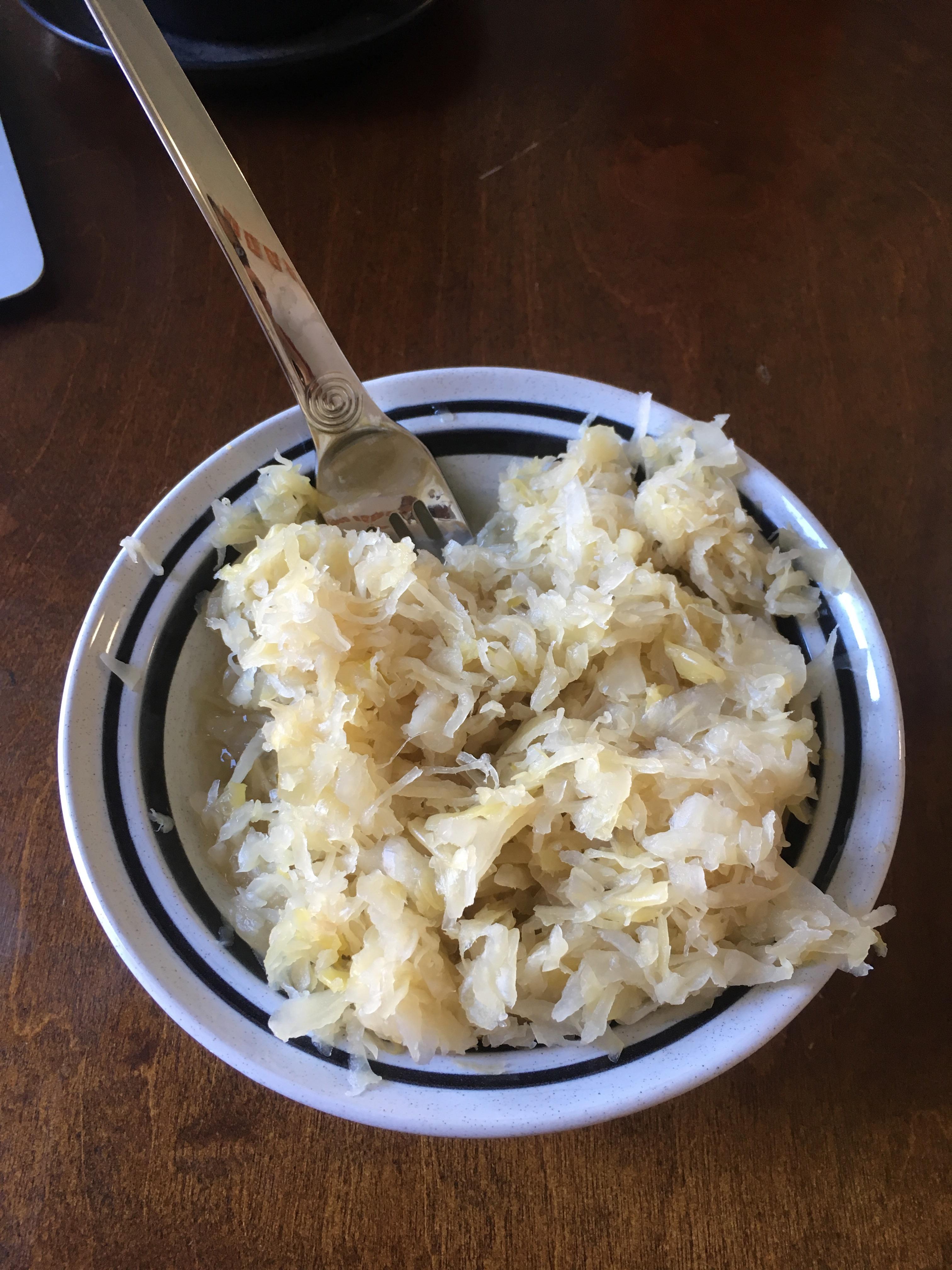 A can of sauerkraut dumped into a bowl. Bonus can was severely dented