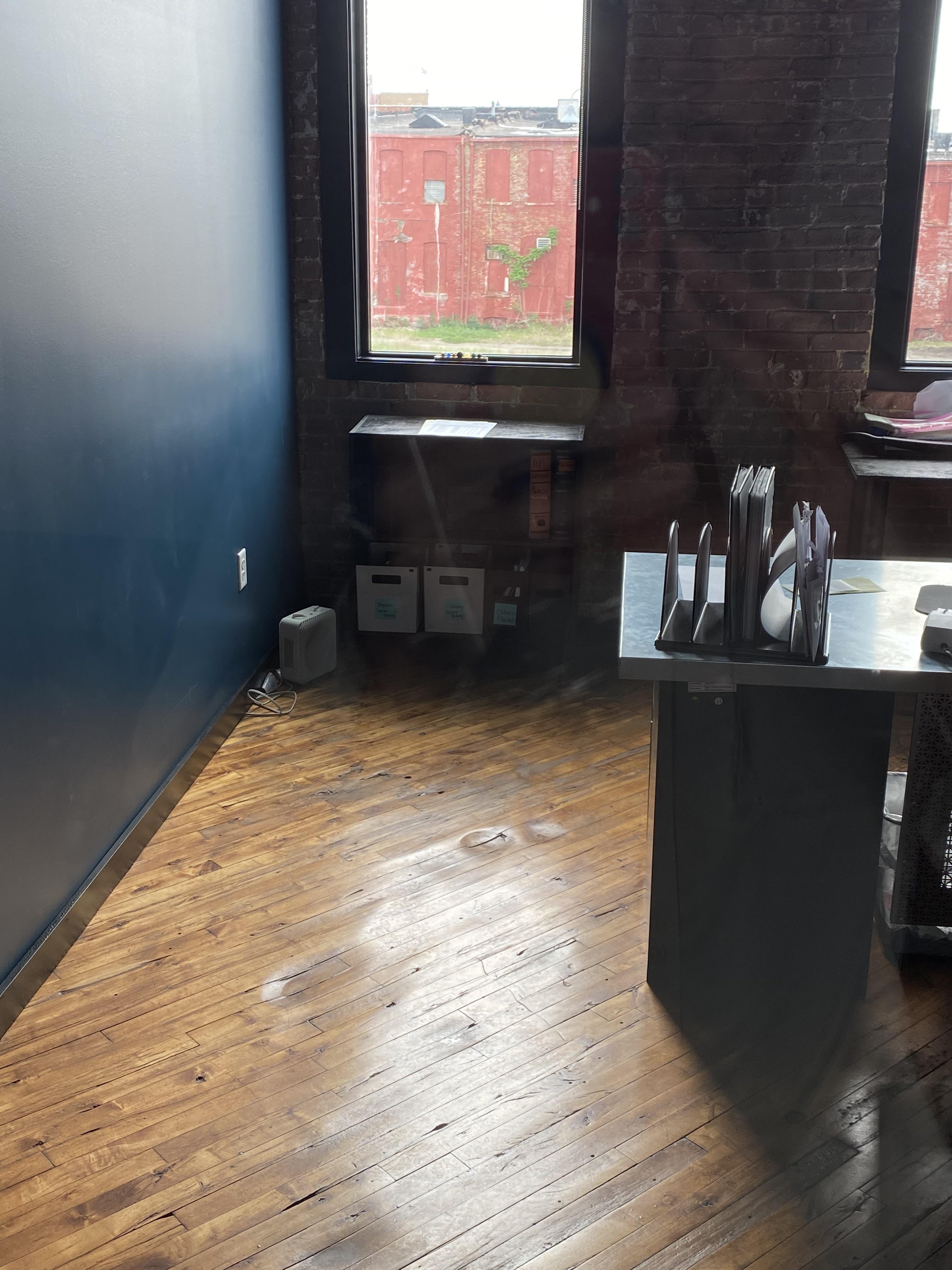 Wear marks in the floor of a repurposed Levi’s denim factory. Someone