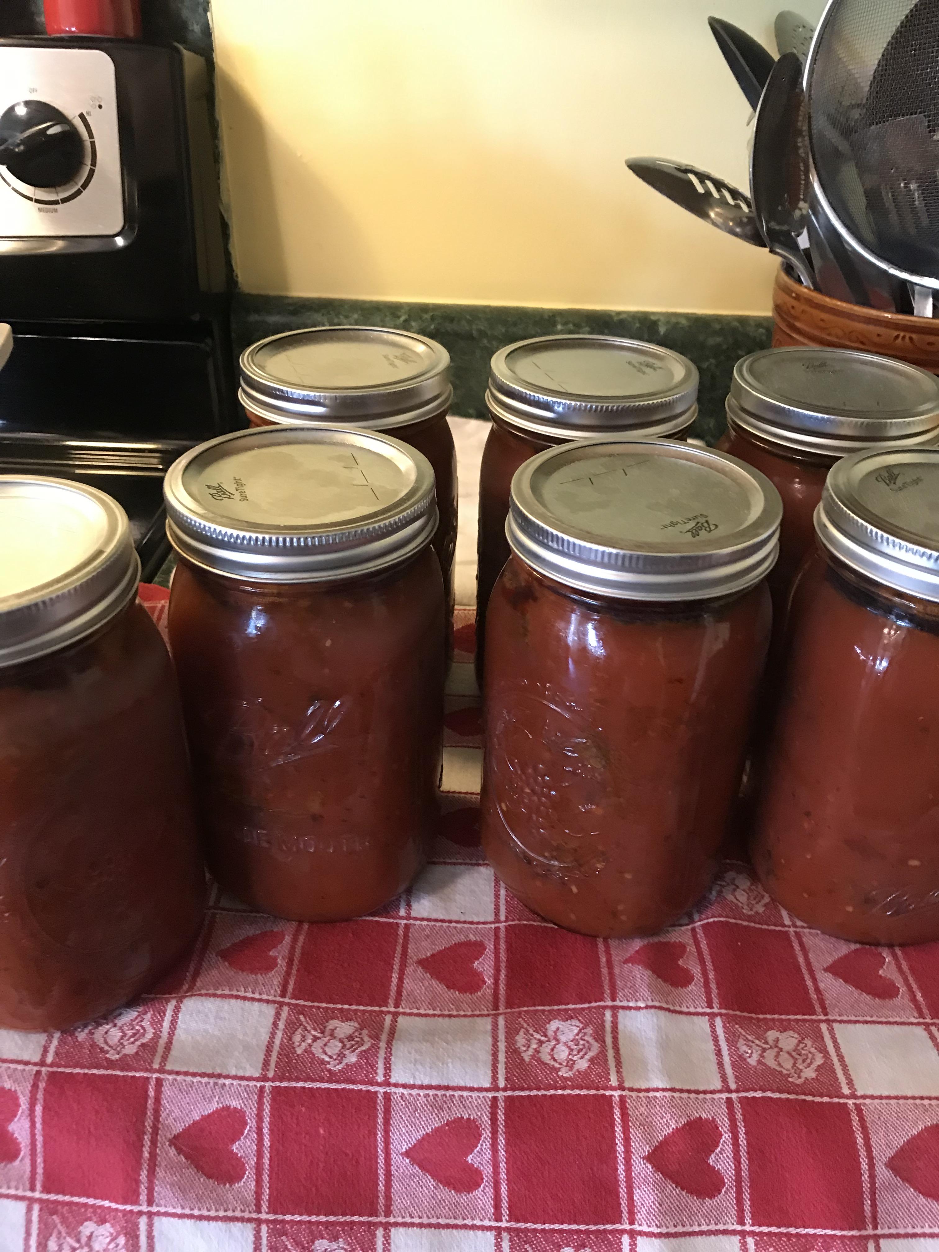 Husband and wife team today , canning homemade sauce with meatballs. 7