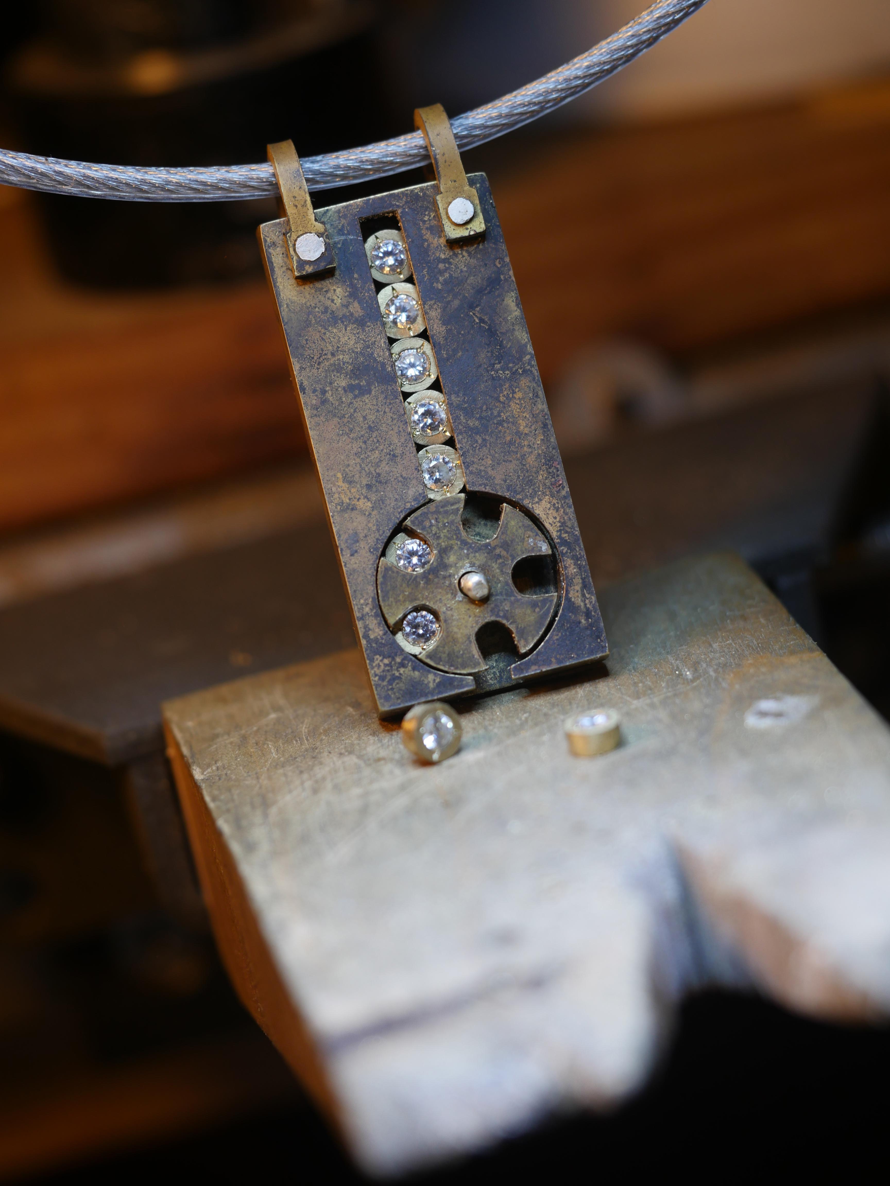 I made this pendant where the stones fall out randomly to think about