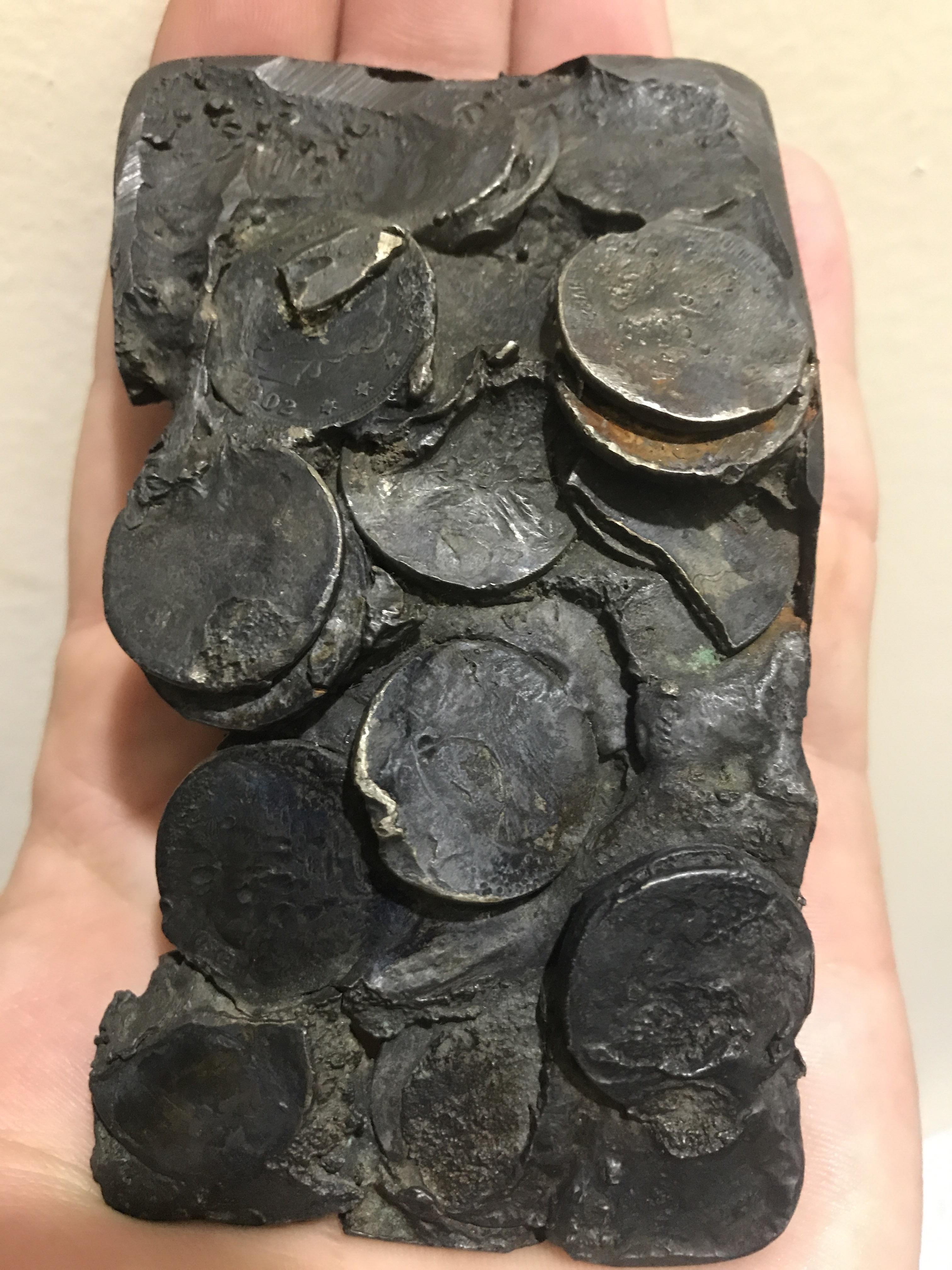 Coins melted by a house fire. Oldest date visible is 1902! r