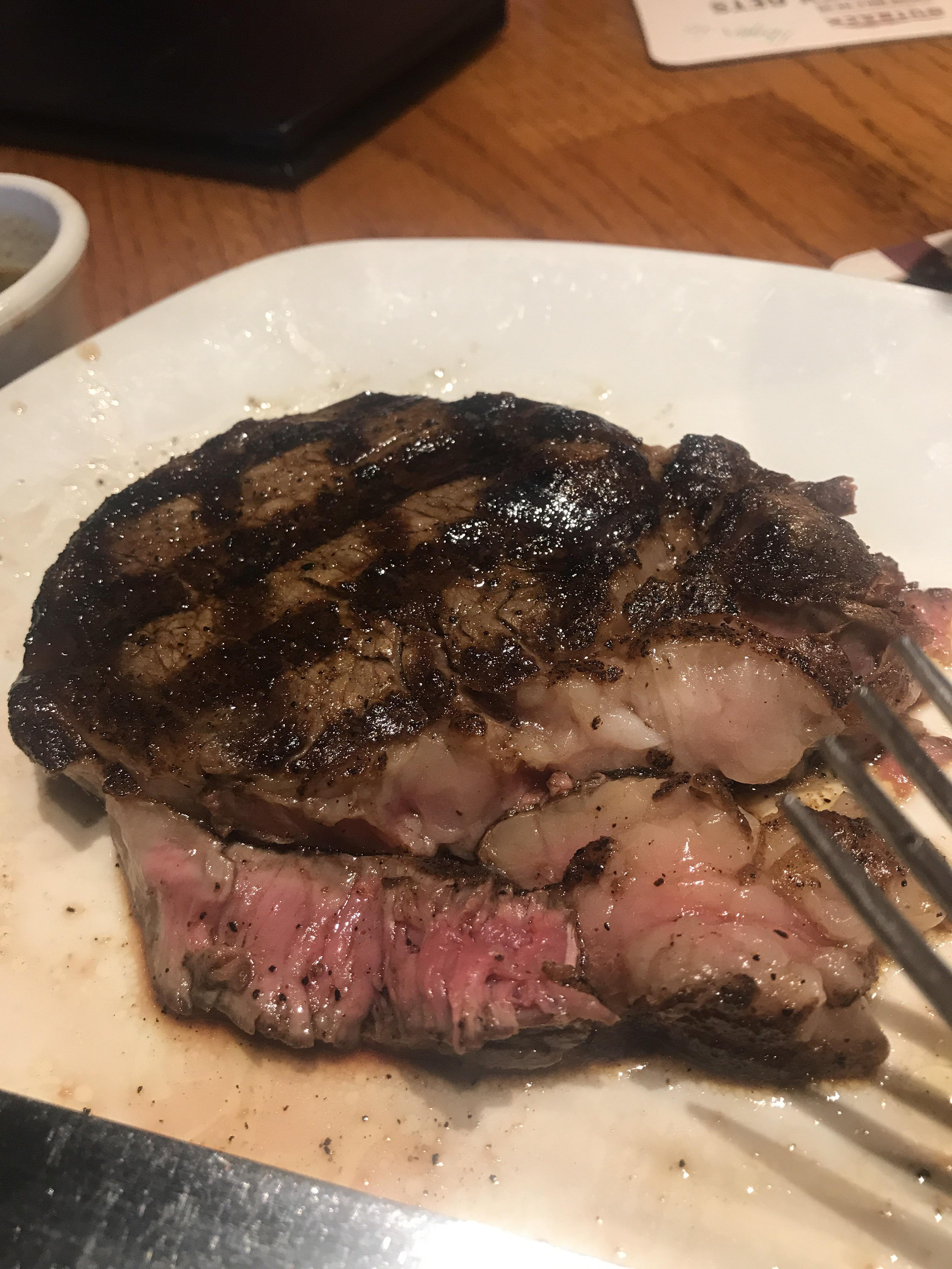 Ribeye steak wood fire grilled at a restaurant [OC] r/FoodPorn