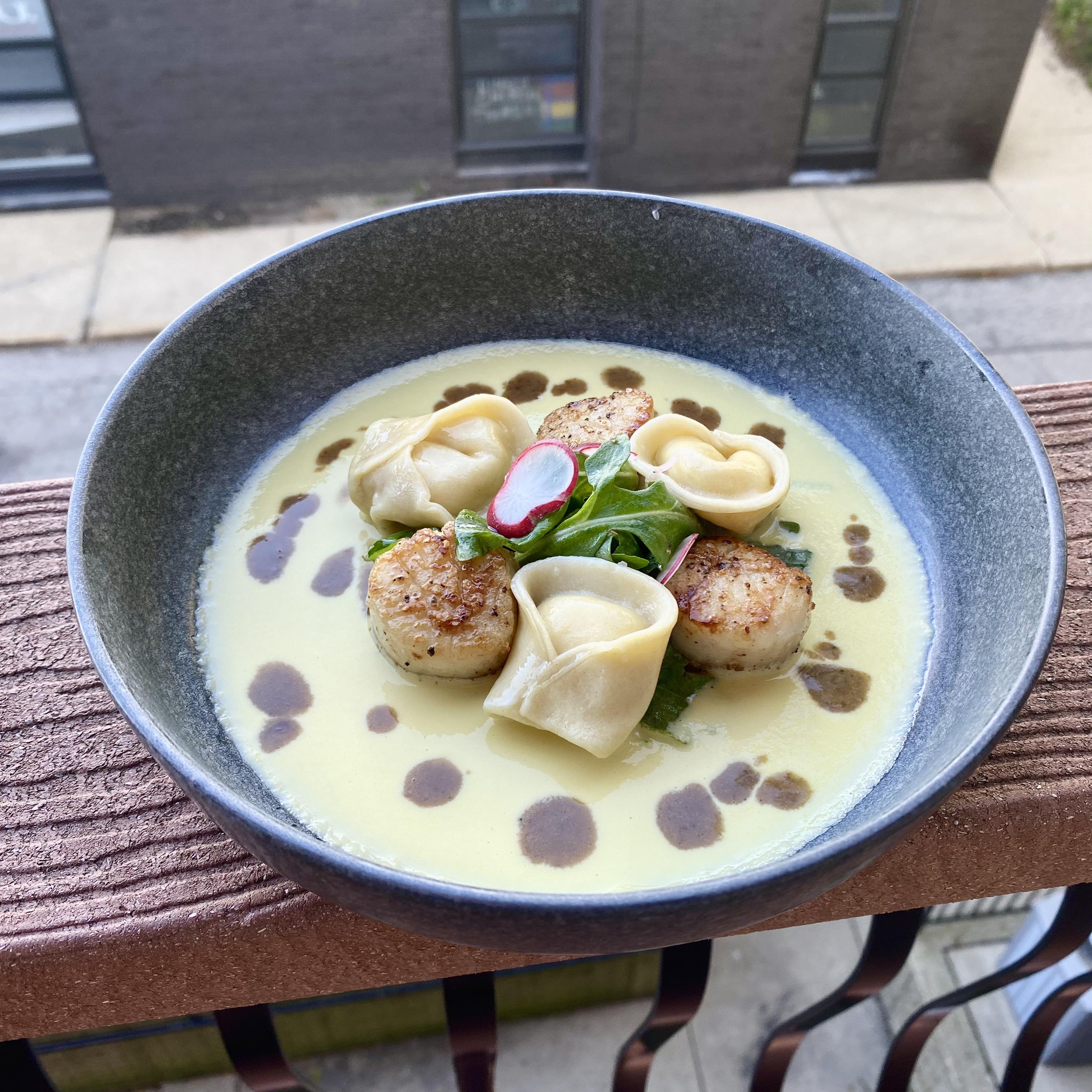 Seared scallops, lemon ricotta tortellini, arugula, sweet corn puree