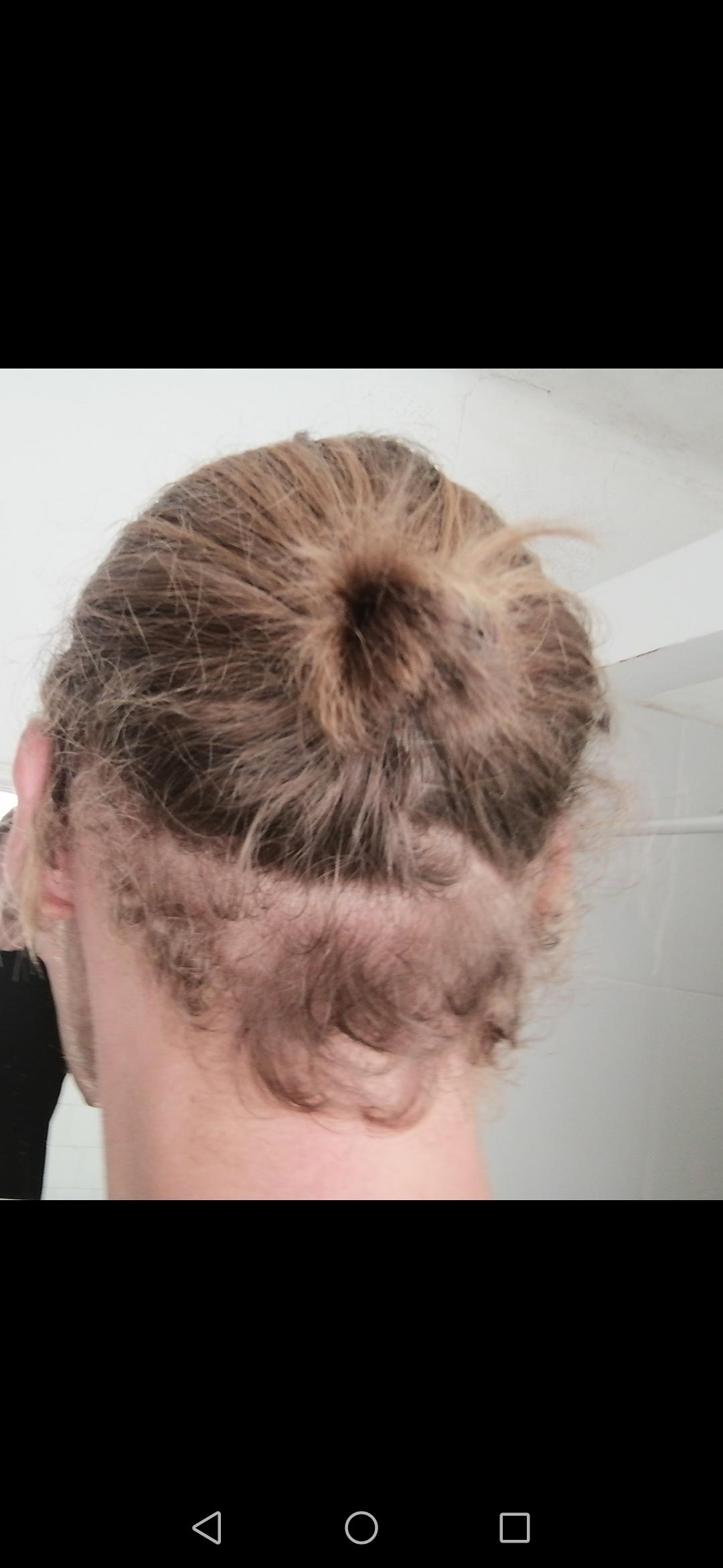 Trim the curly hair, or wait until it's long enough to tie it up with