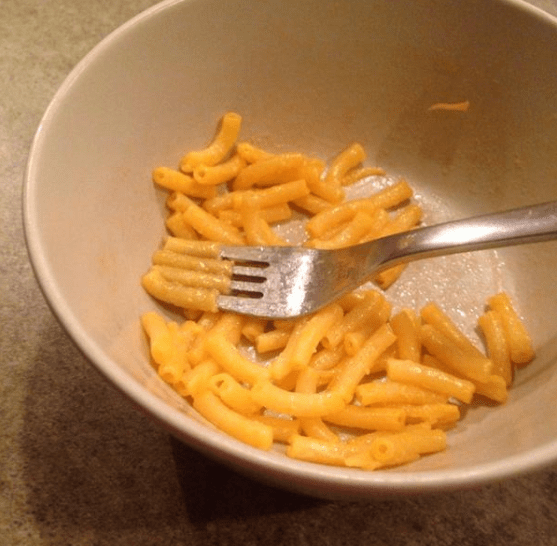 Eating Mac n' Cheese by arranging a single noodle on each fork tine