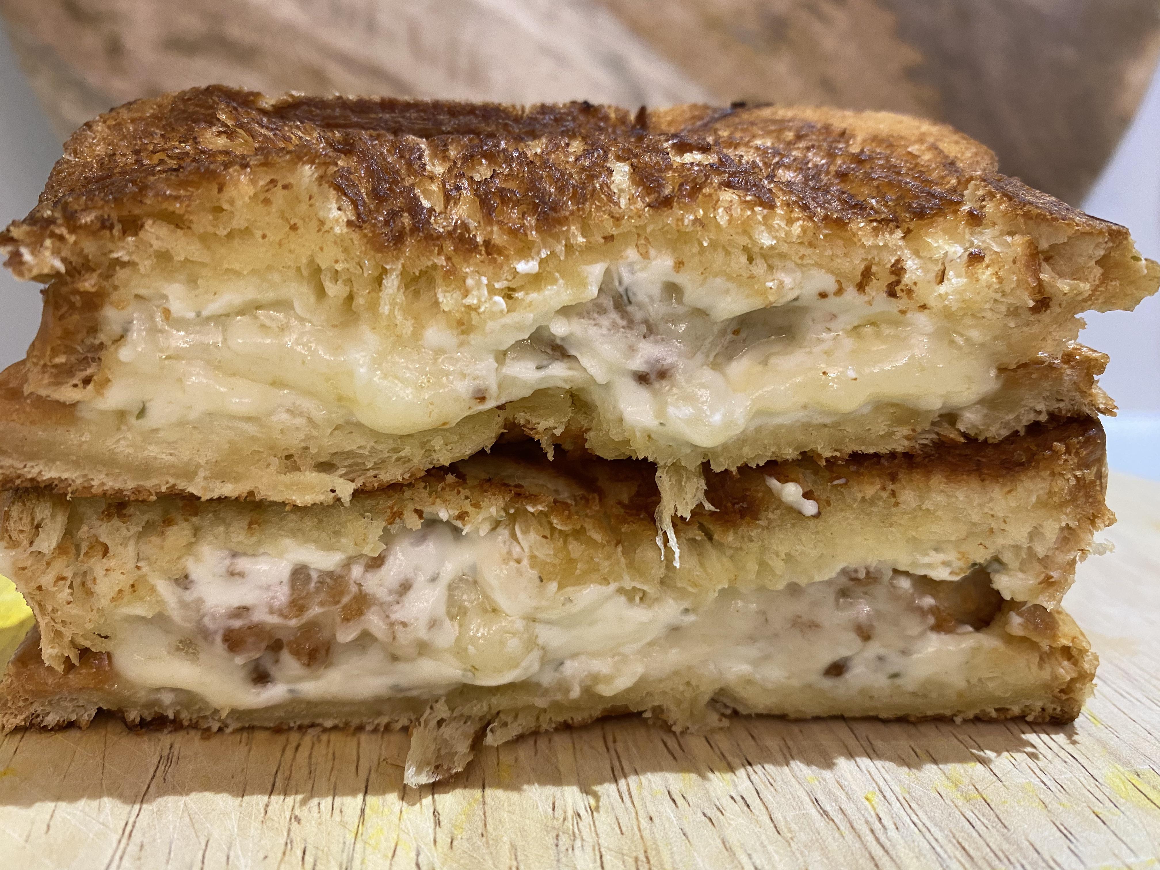 Deep fried Brie with garlic and herb cream cheese between buttery