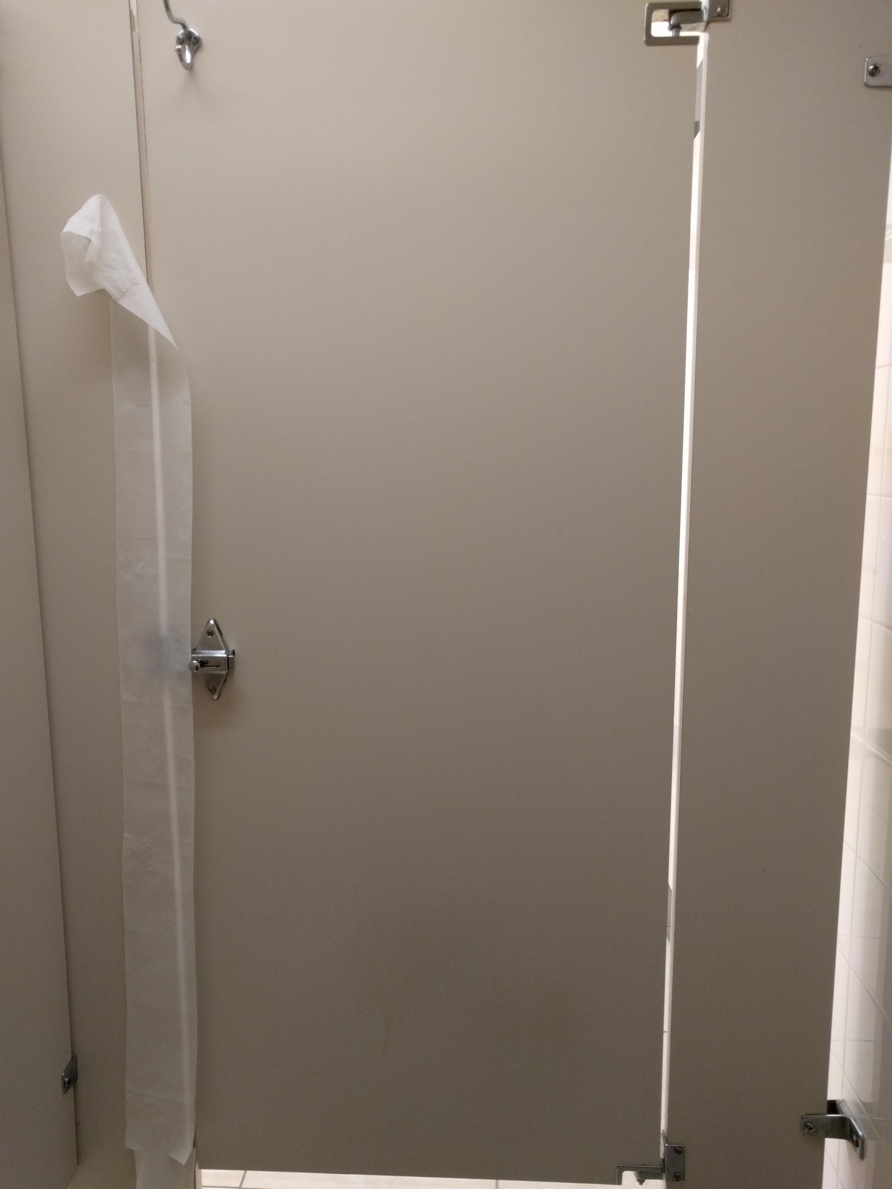 The guy before me wet some toilet paper and stuck it to the bathroom stall to cover the crack