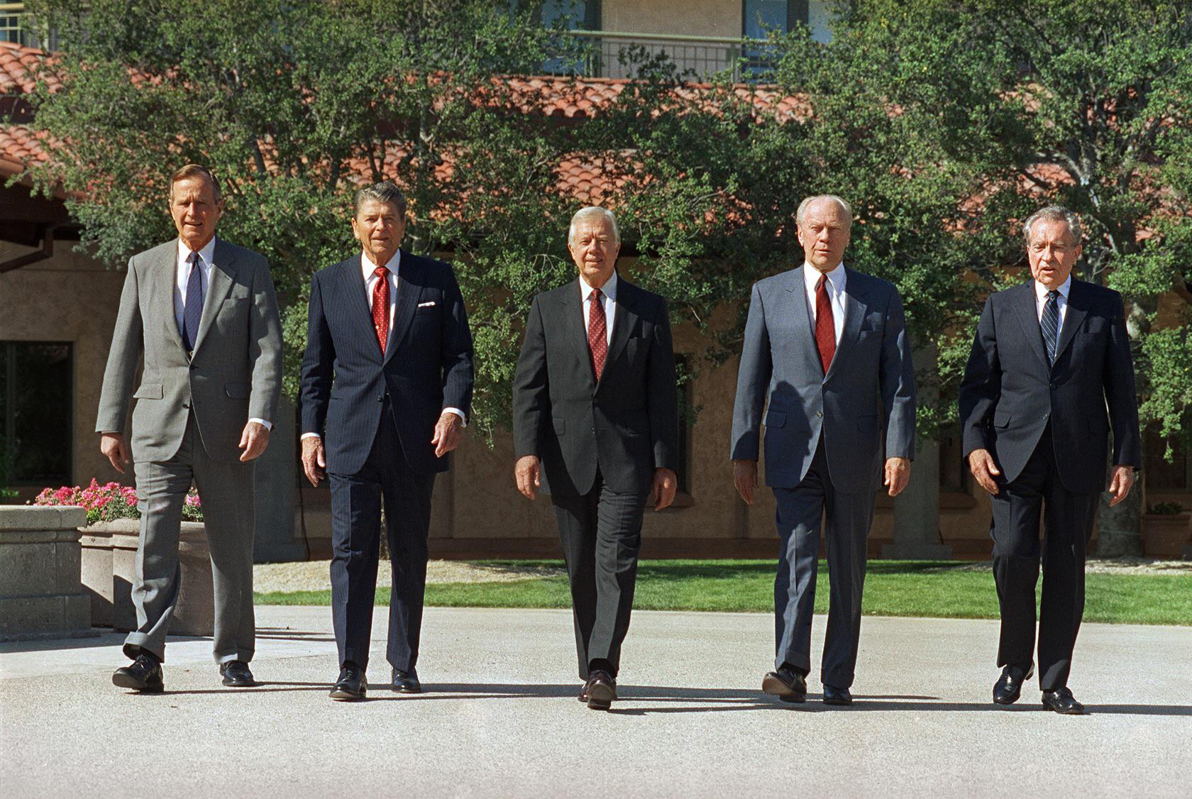 President Bush, left, walks with former Presidents Ronald Reagan