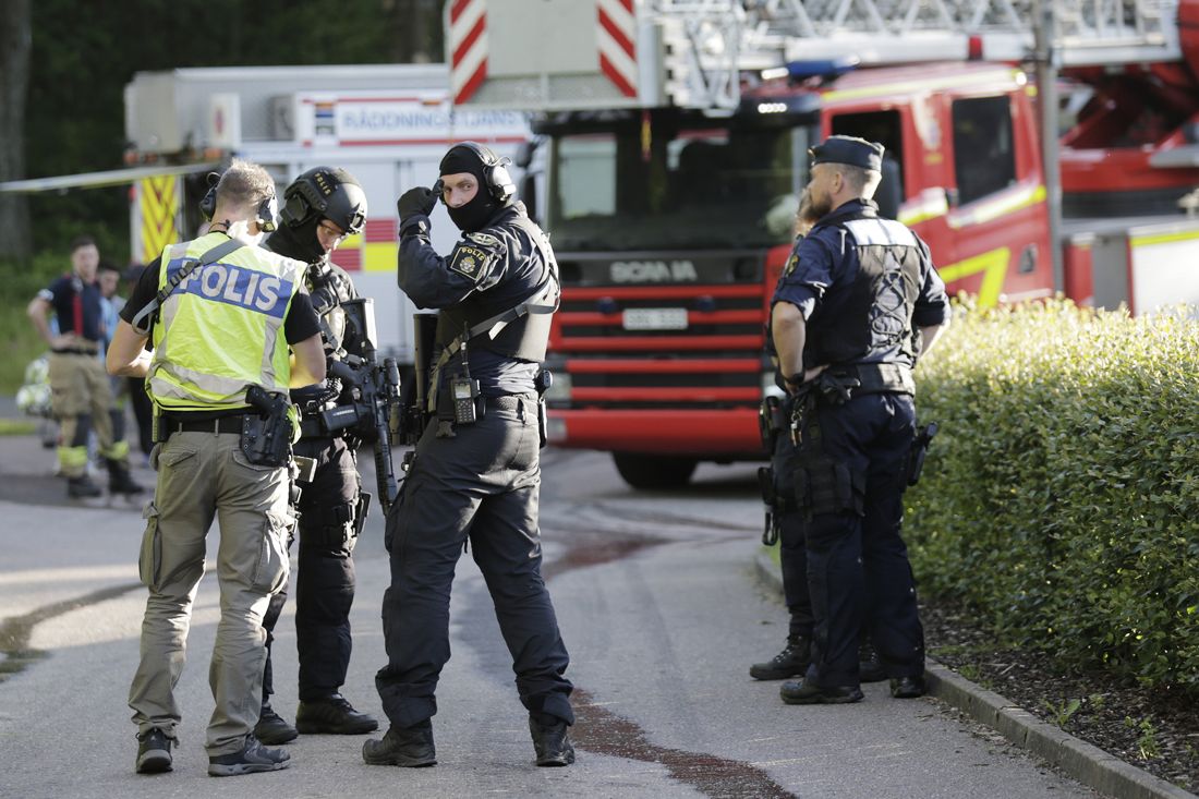 Swedish police officers and task force operators at the scene after a