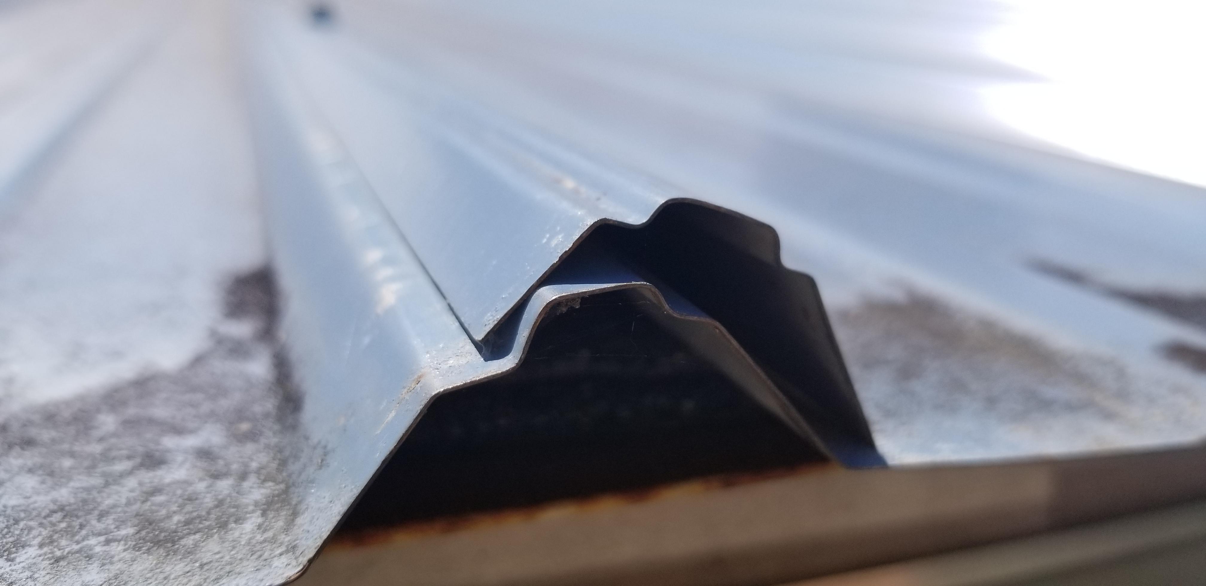 Is this what's causing my metal roof to leak? All the seams are loose with no screws, and many