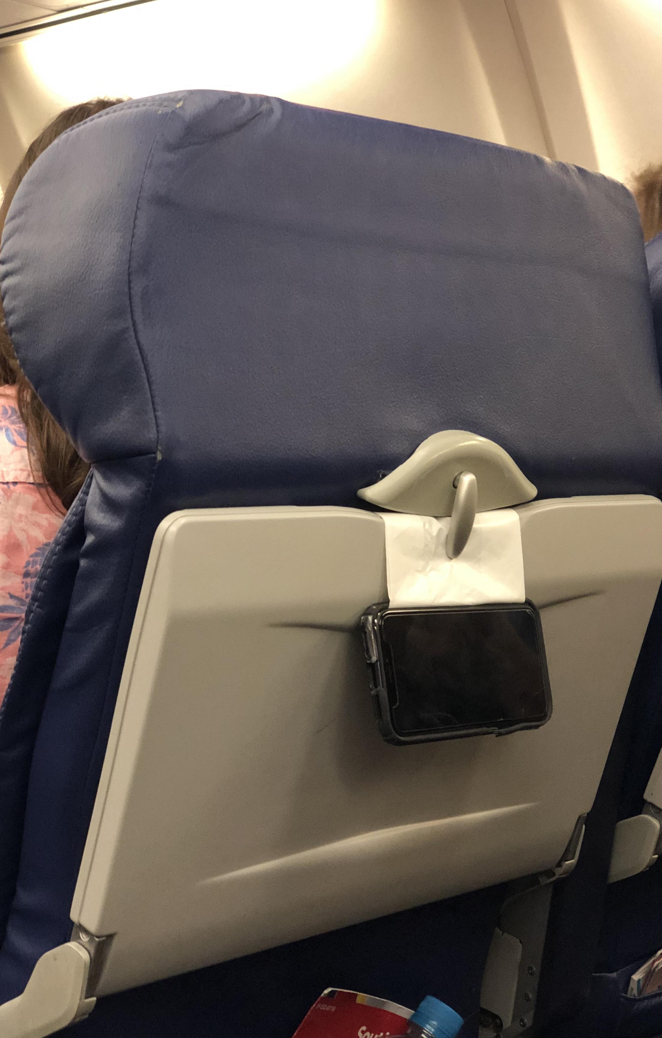 Airplane Phone Holder Tuck the bottom end of the barf bag in between