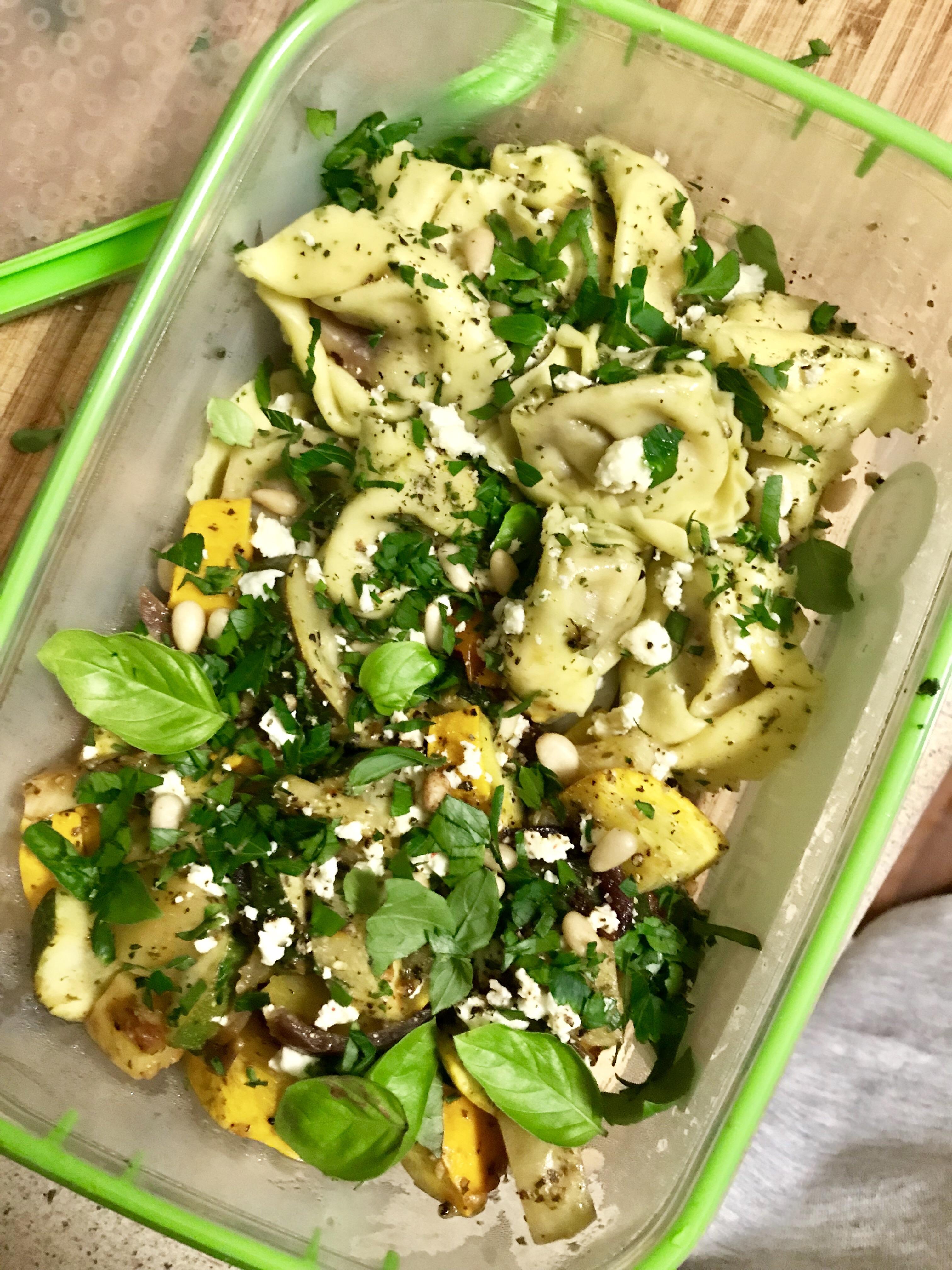 Dinner feta and olive tortellini with pesto and roasted vegetables
