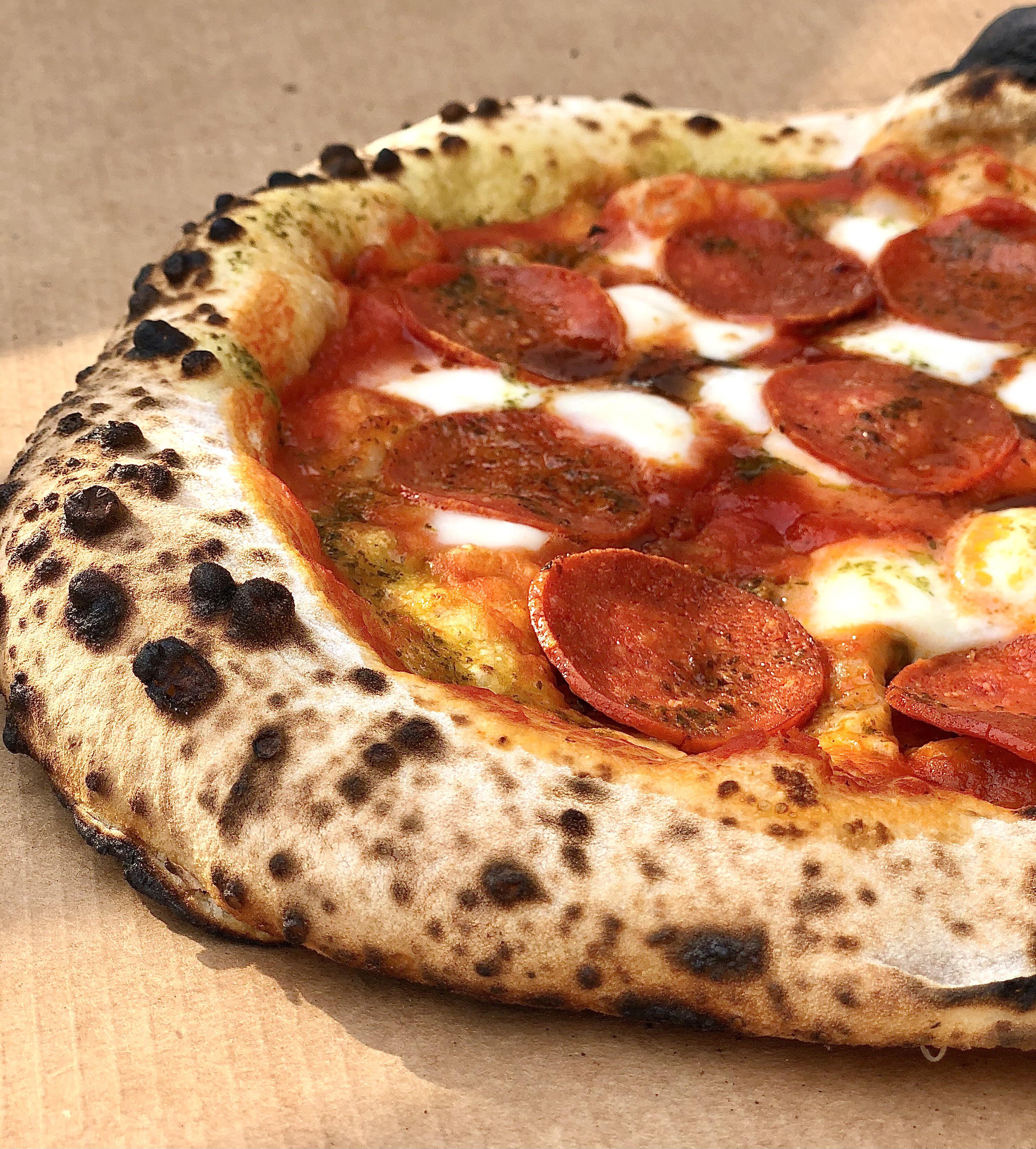 Sourdough pizza with pepperoni, fior de latte and basil oil. Wood fired