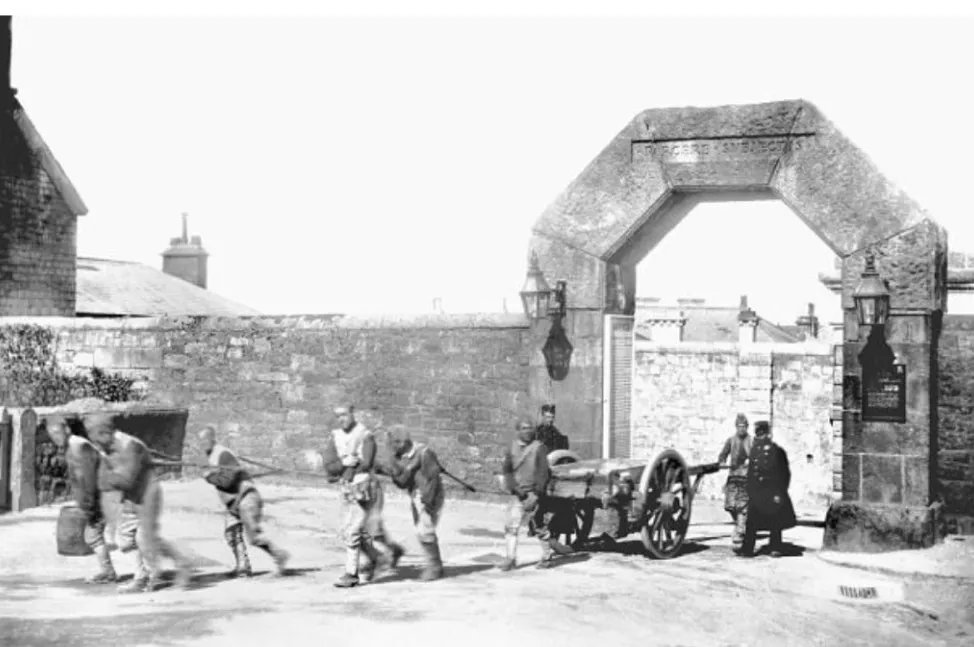 Shackled criminals can be seen dragging a cart through the gates of