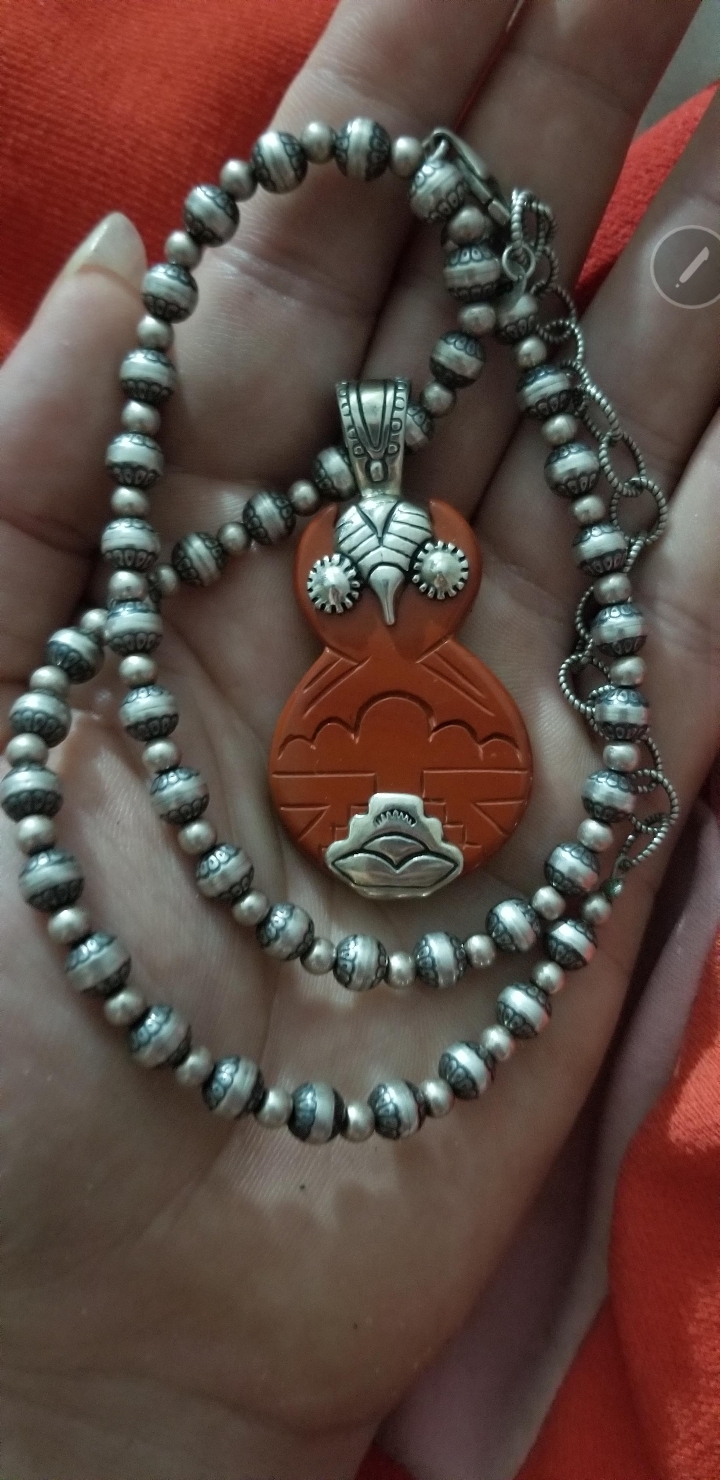 Seeking help identifying what the orange part of this owl is made of