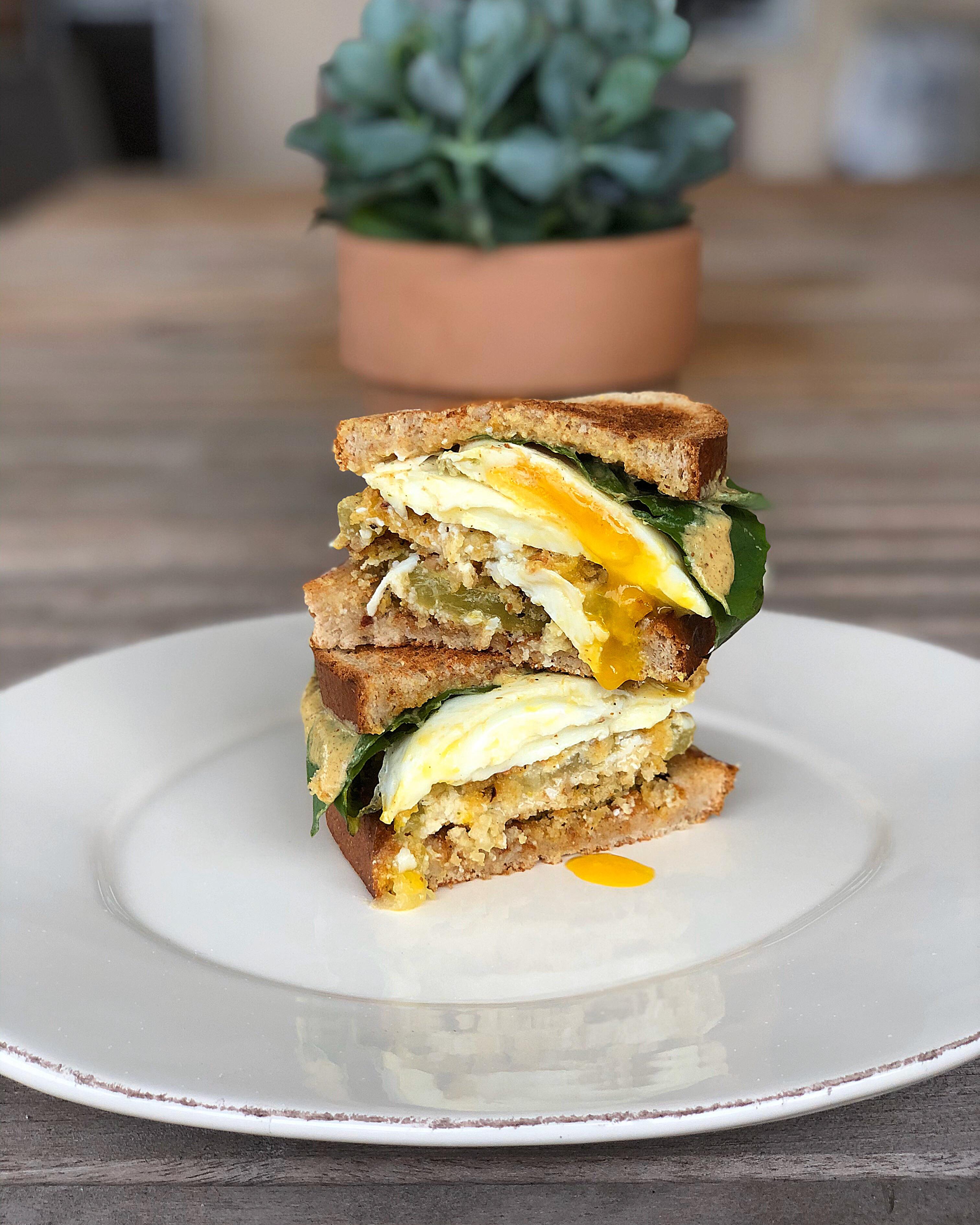 Fried green tomato egg sandwiches topped with dijon aioli and fresh