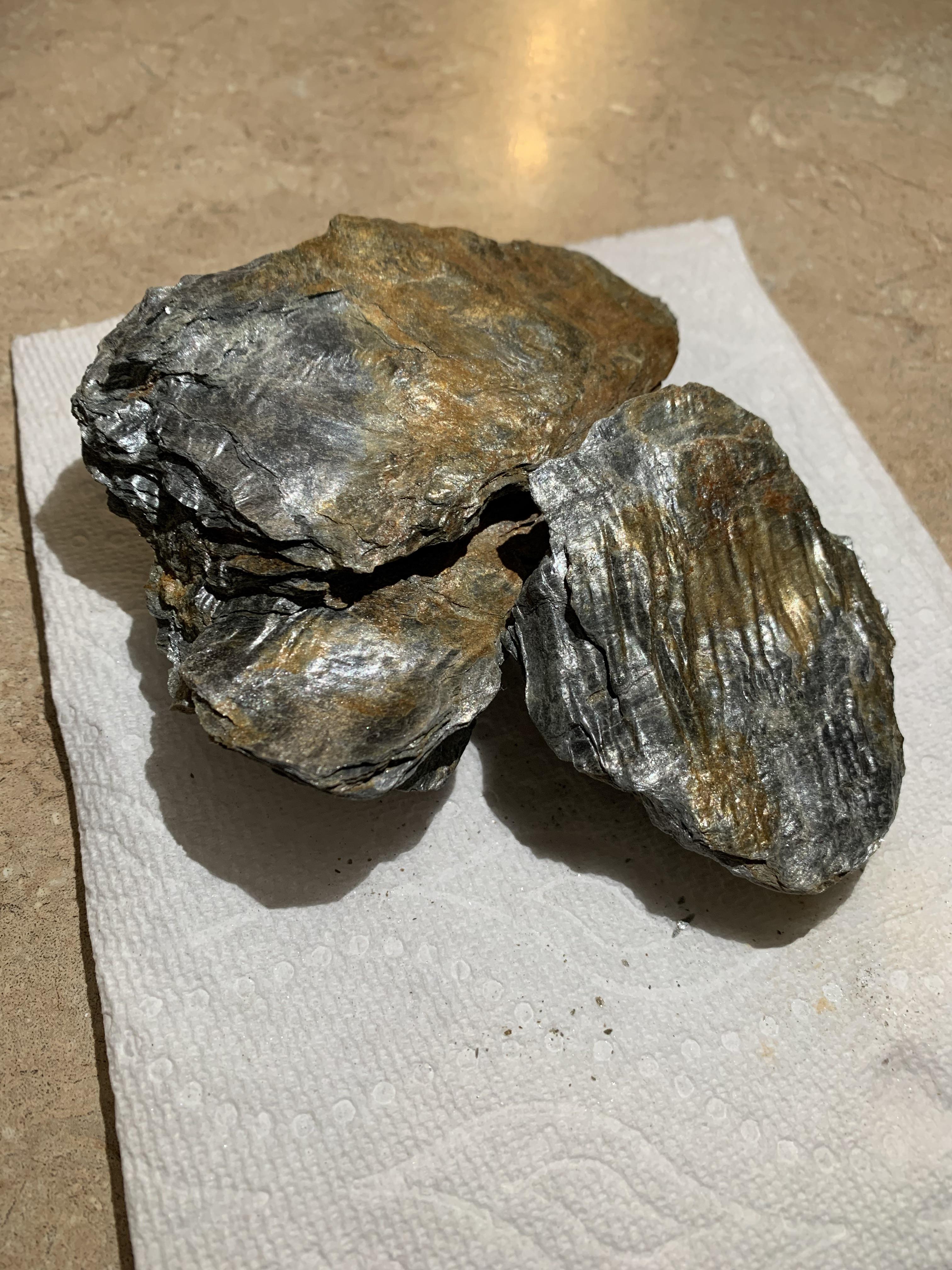 Can somebody help identify this rock? Its shiny and brittle. Has a bit