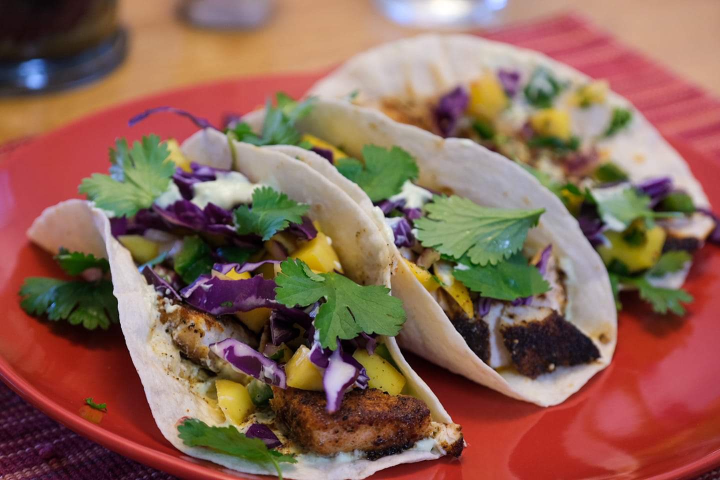 Blackened mahi mahi tacos with mango salsa and avocado crema. r/LunchPorn