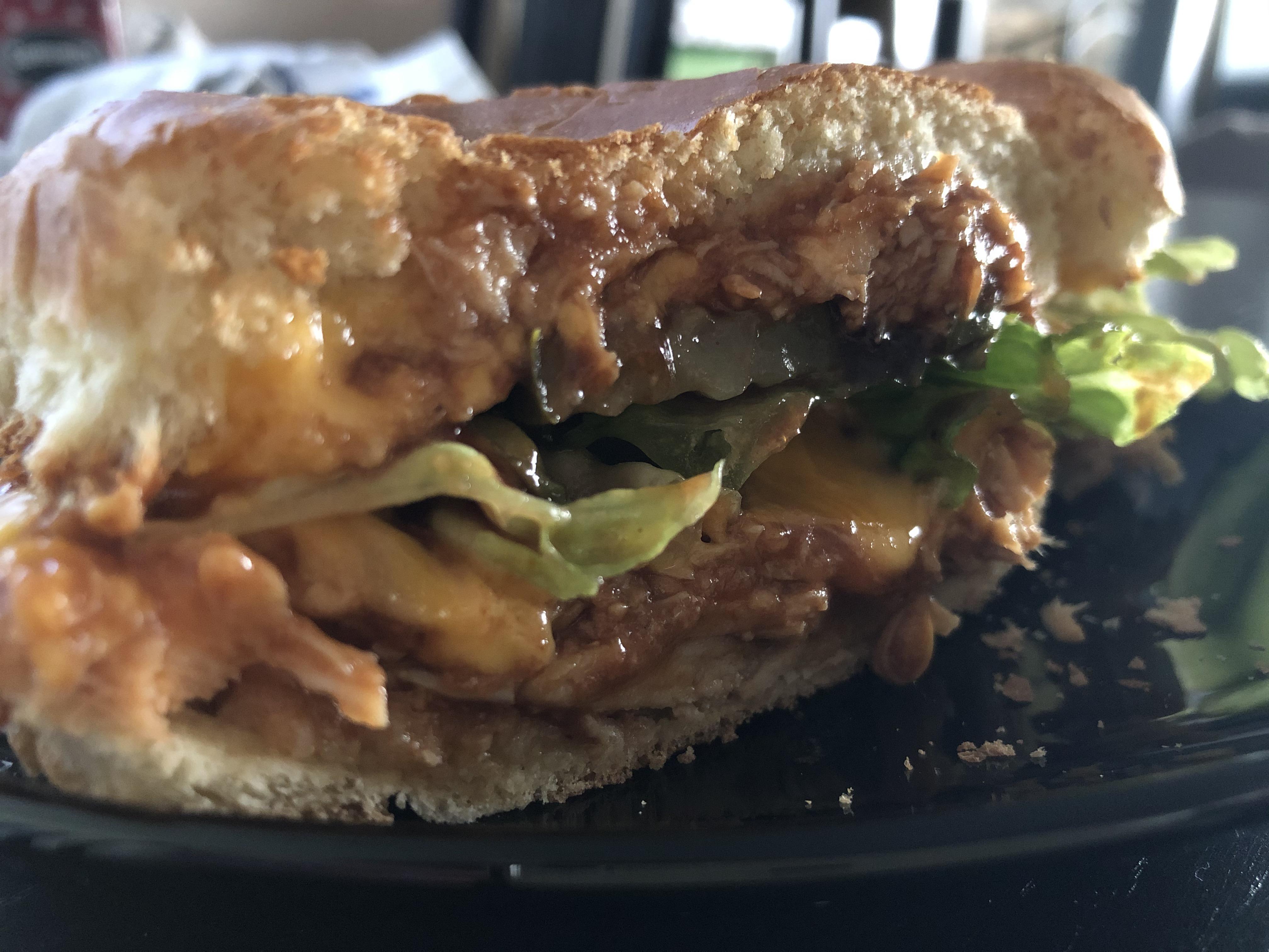 A baked barbecue chicken melt with lettuce and pickles. r/melts