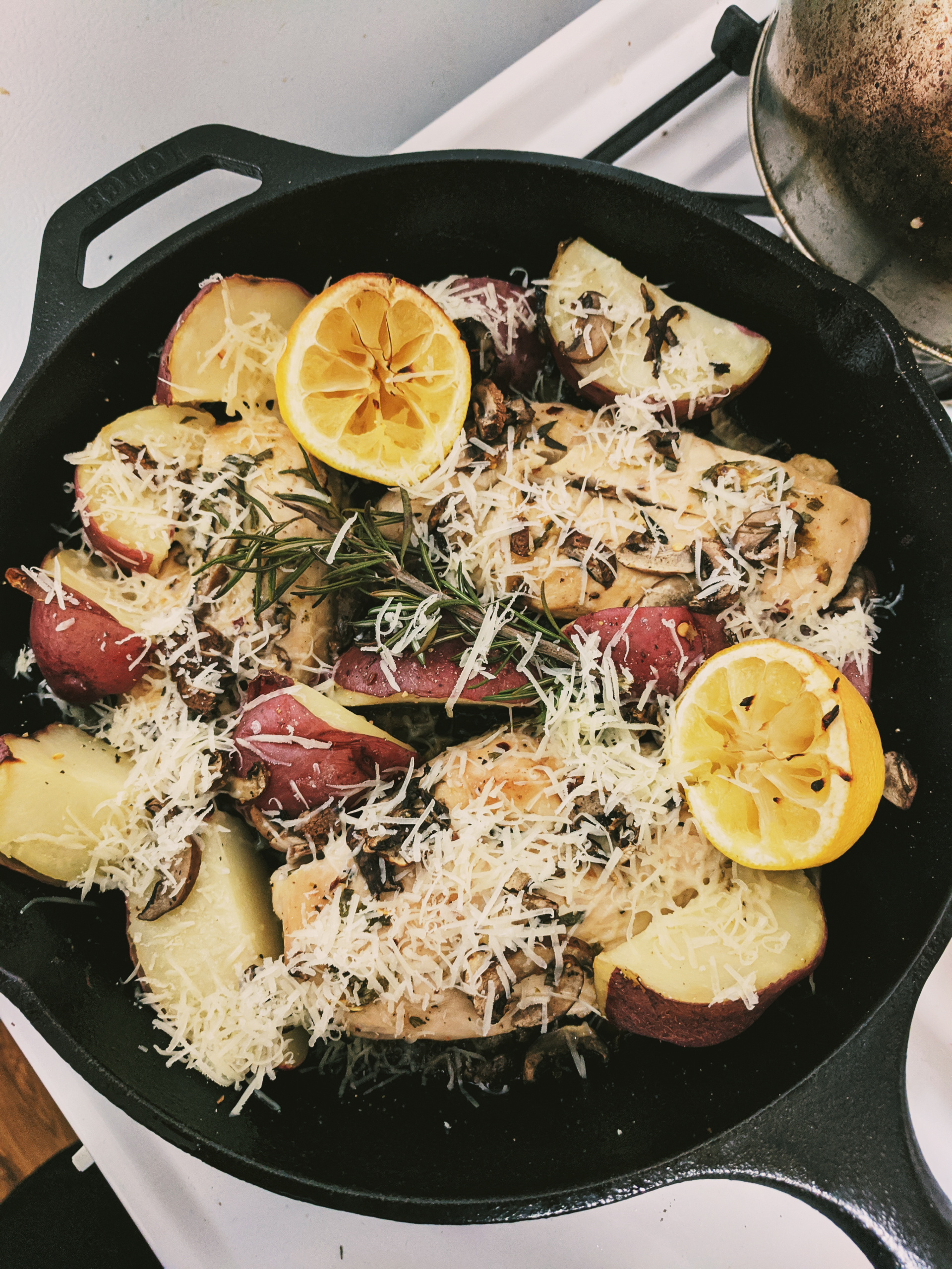 Oven Baked Rosemary Lemon Chicken with Potatoes and Mushrooms topped