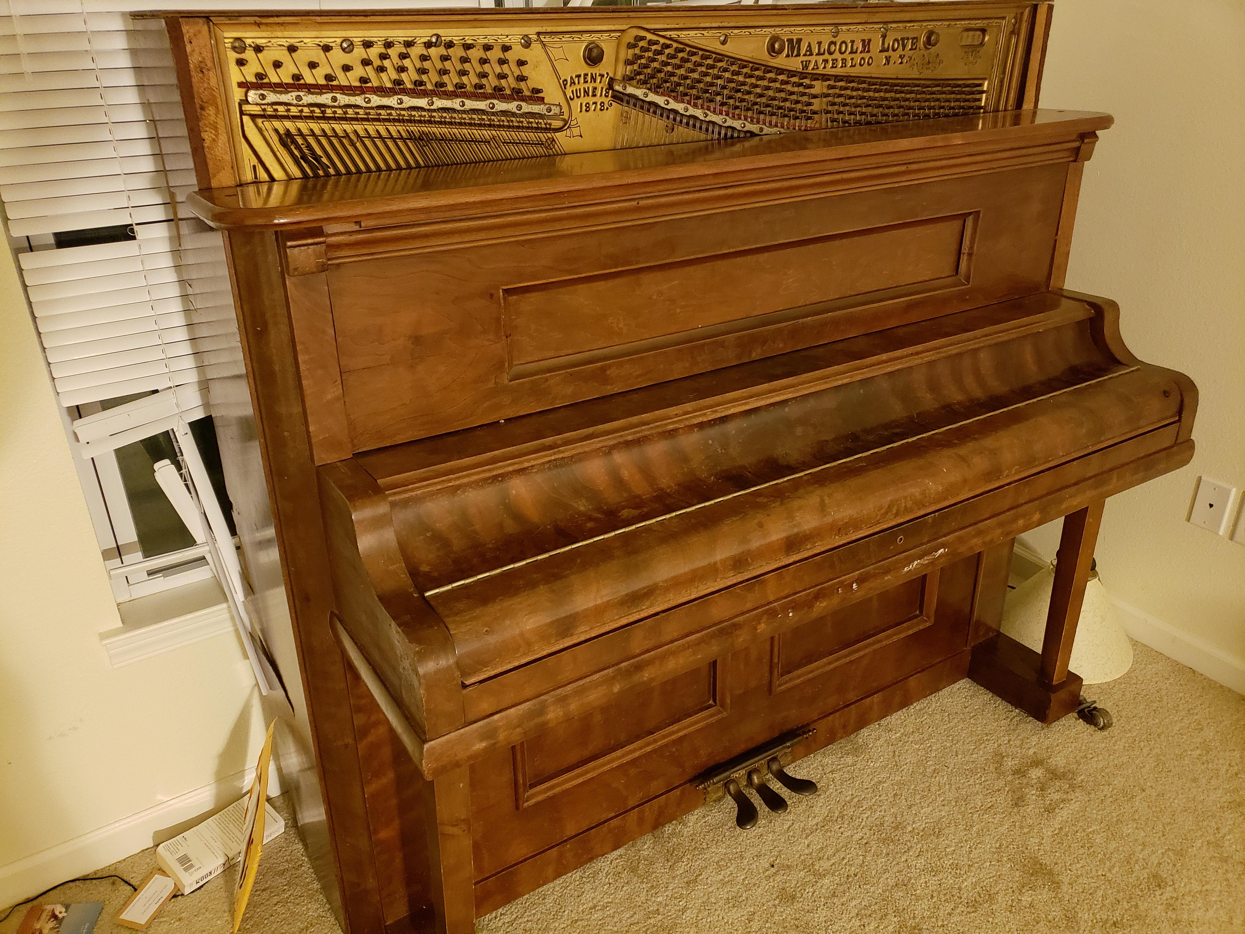 Purchased a Malcolm Love piano built in 1878. Some of the wood paneling