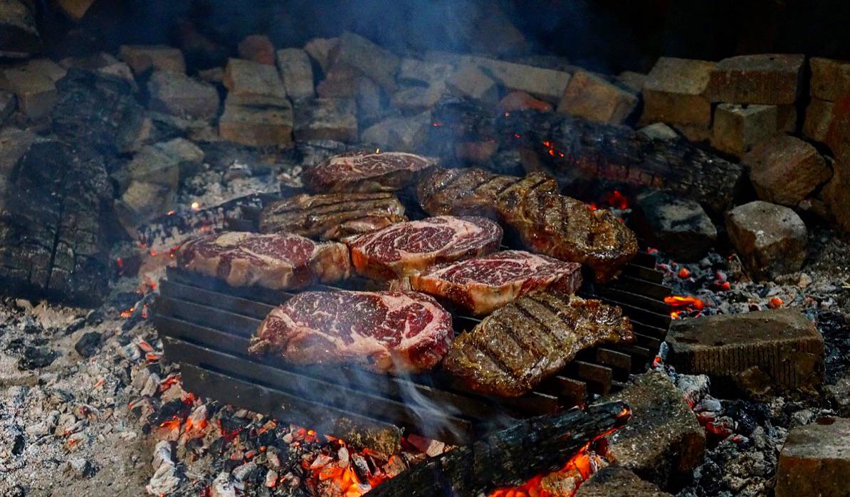 Ribeyes over a bed of coals. Seasoned only with S&P. r/FoodPorn