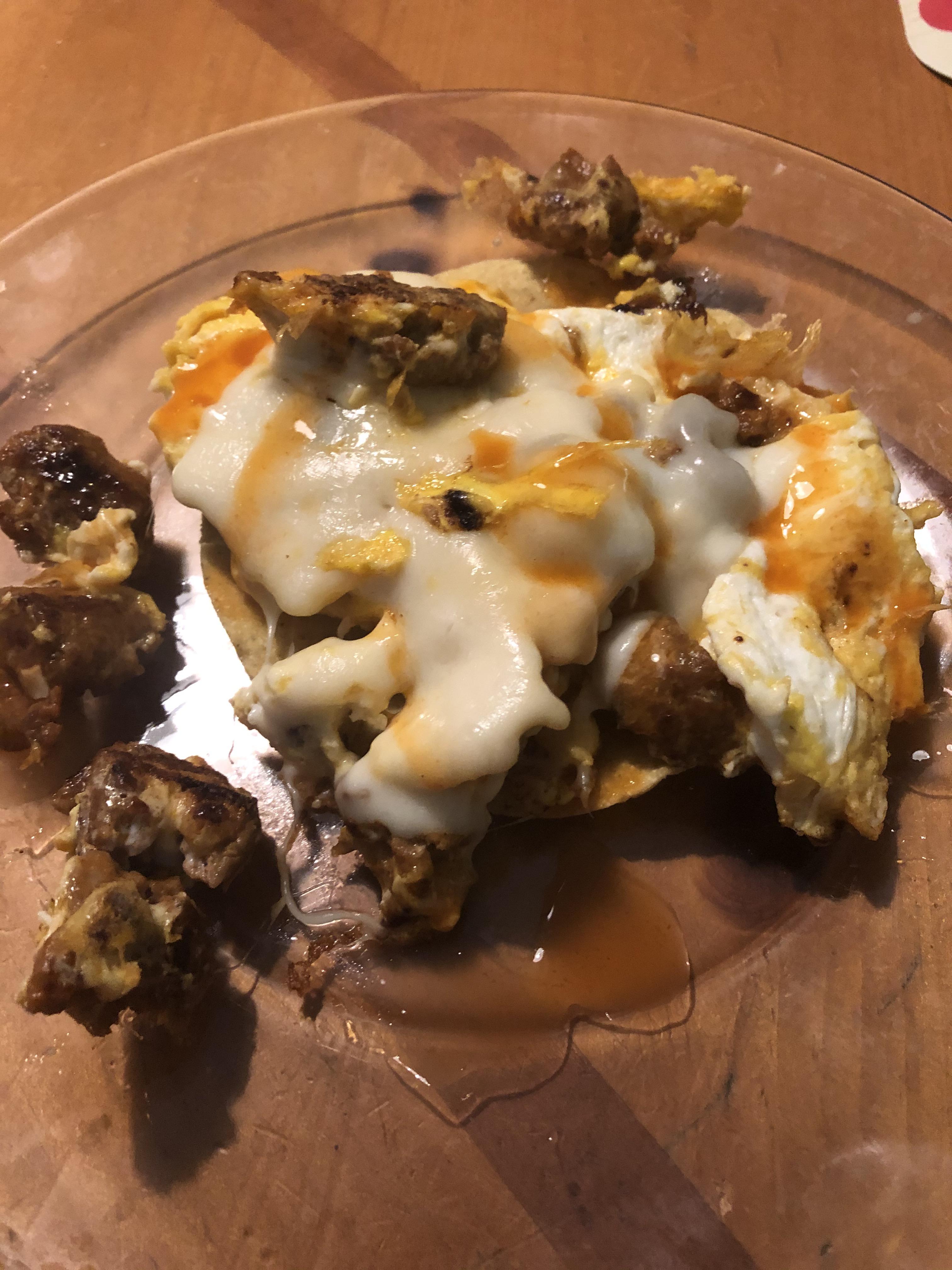 Chorizo, scrambled eggs,Havarti cheese on a tostada with hot sauce