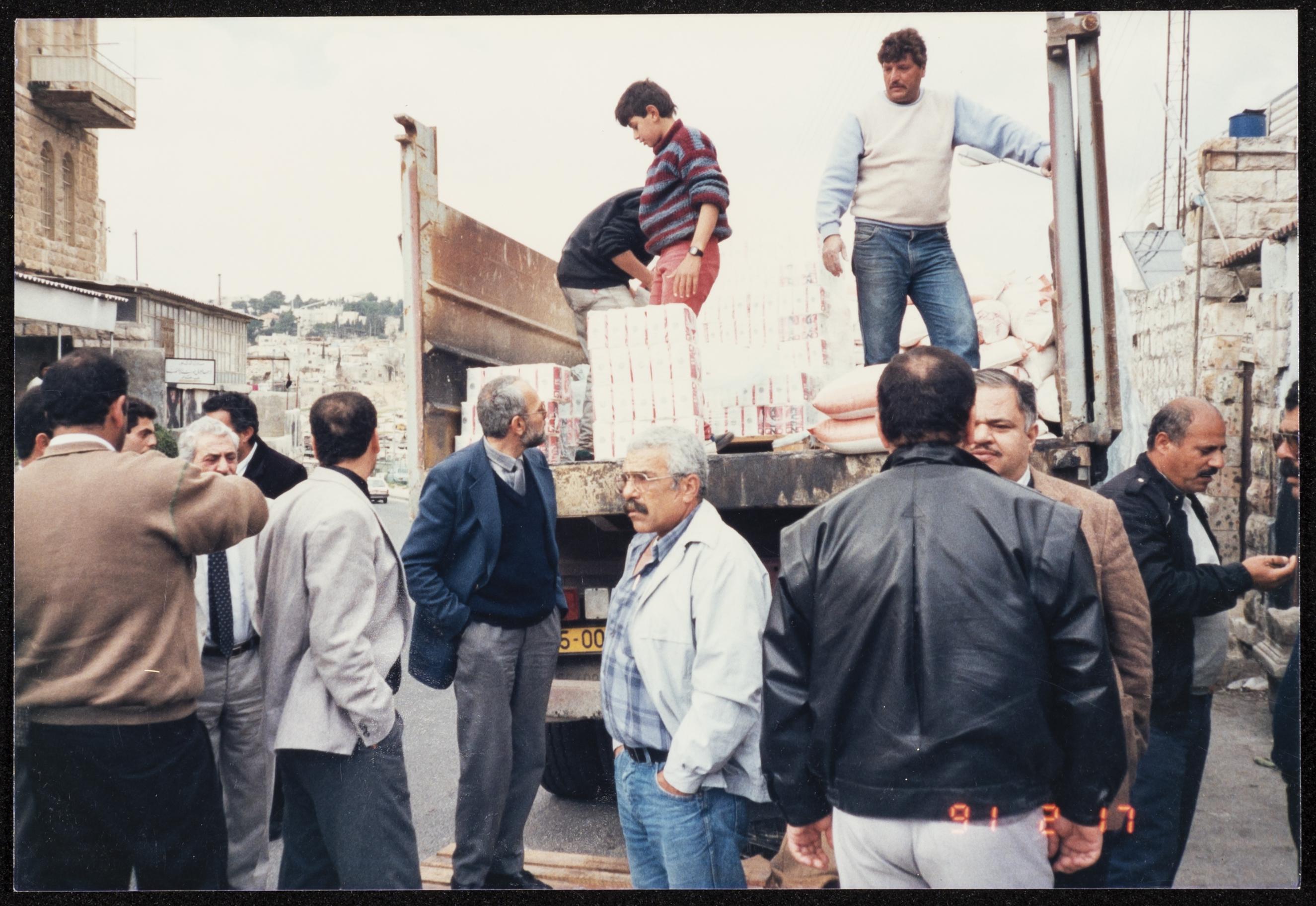 A photograph of Palestinians sending aid and food items from Nazareth