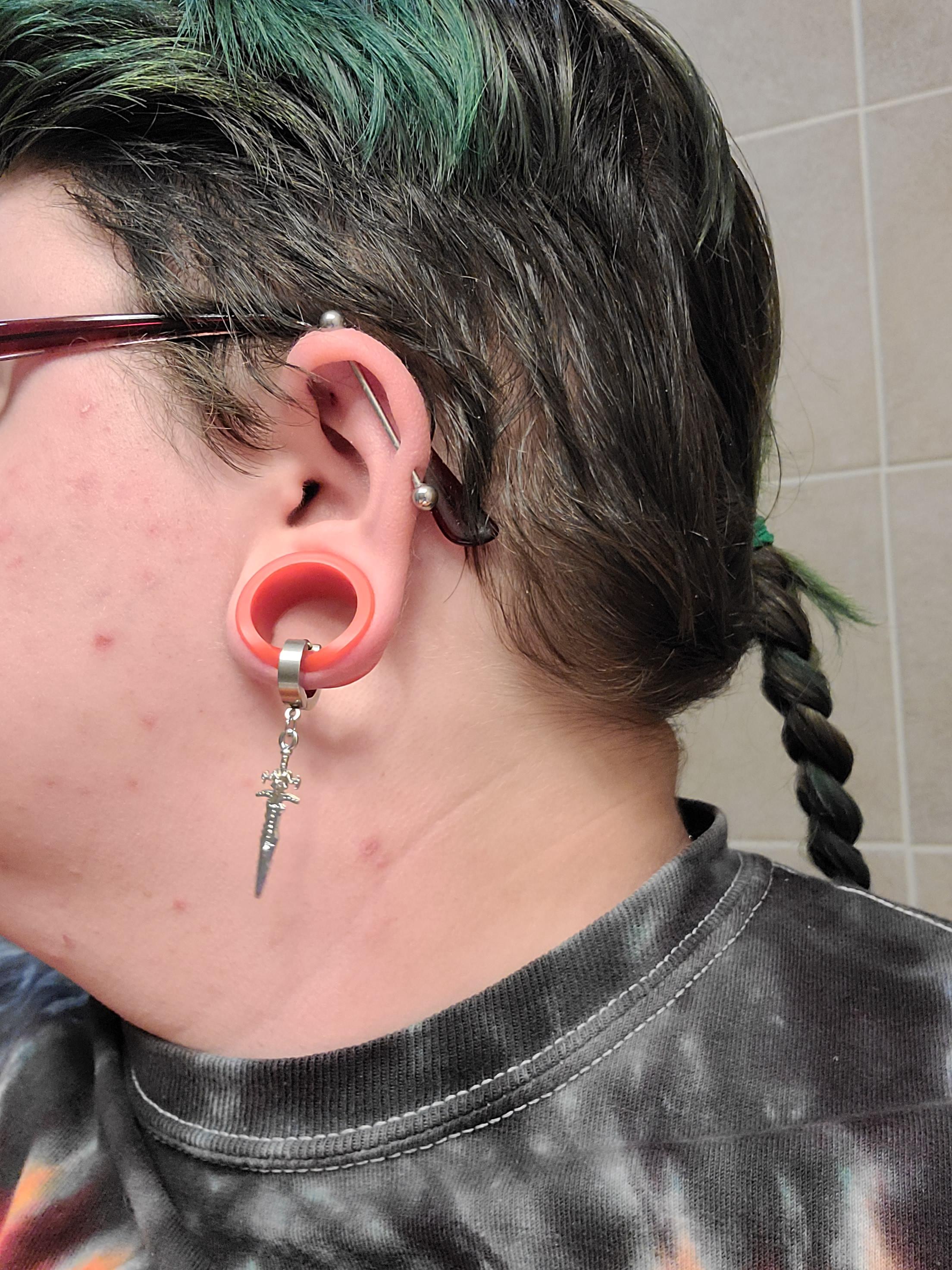 i figured out that i can put a a dangly gay earring through these