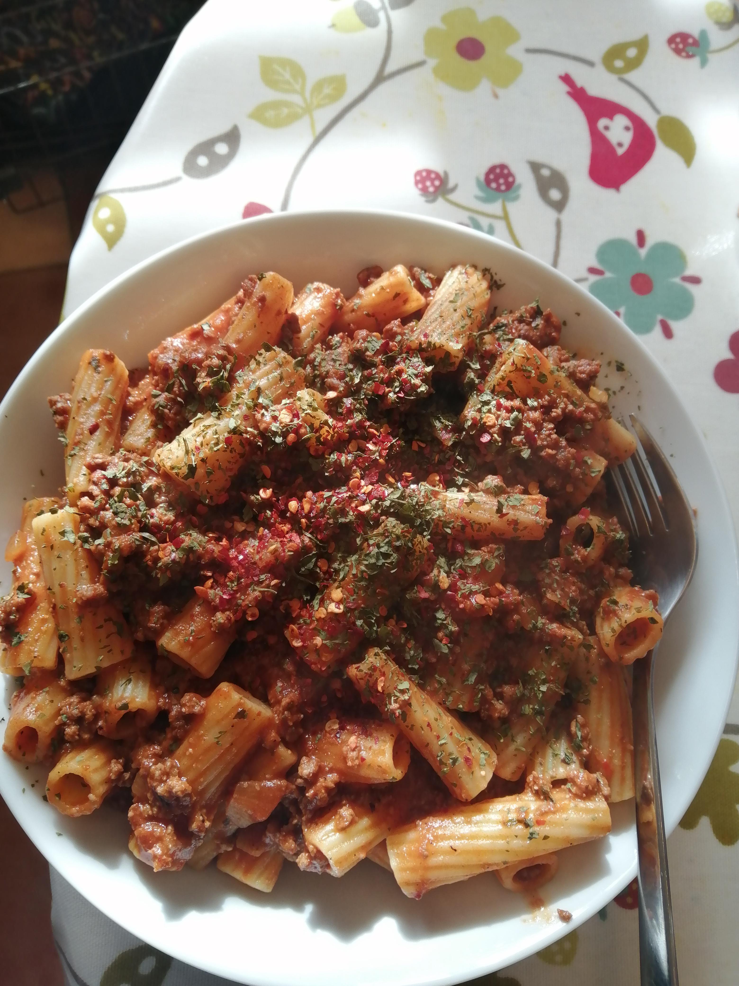 Rigatoni with a homemade spicy bolognese sauce, topped with Italian