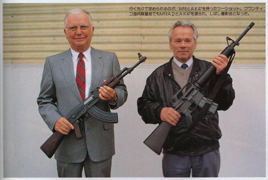 Eugene Stoner and Mikhail Kalashnikov holding each other's inventions