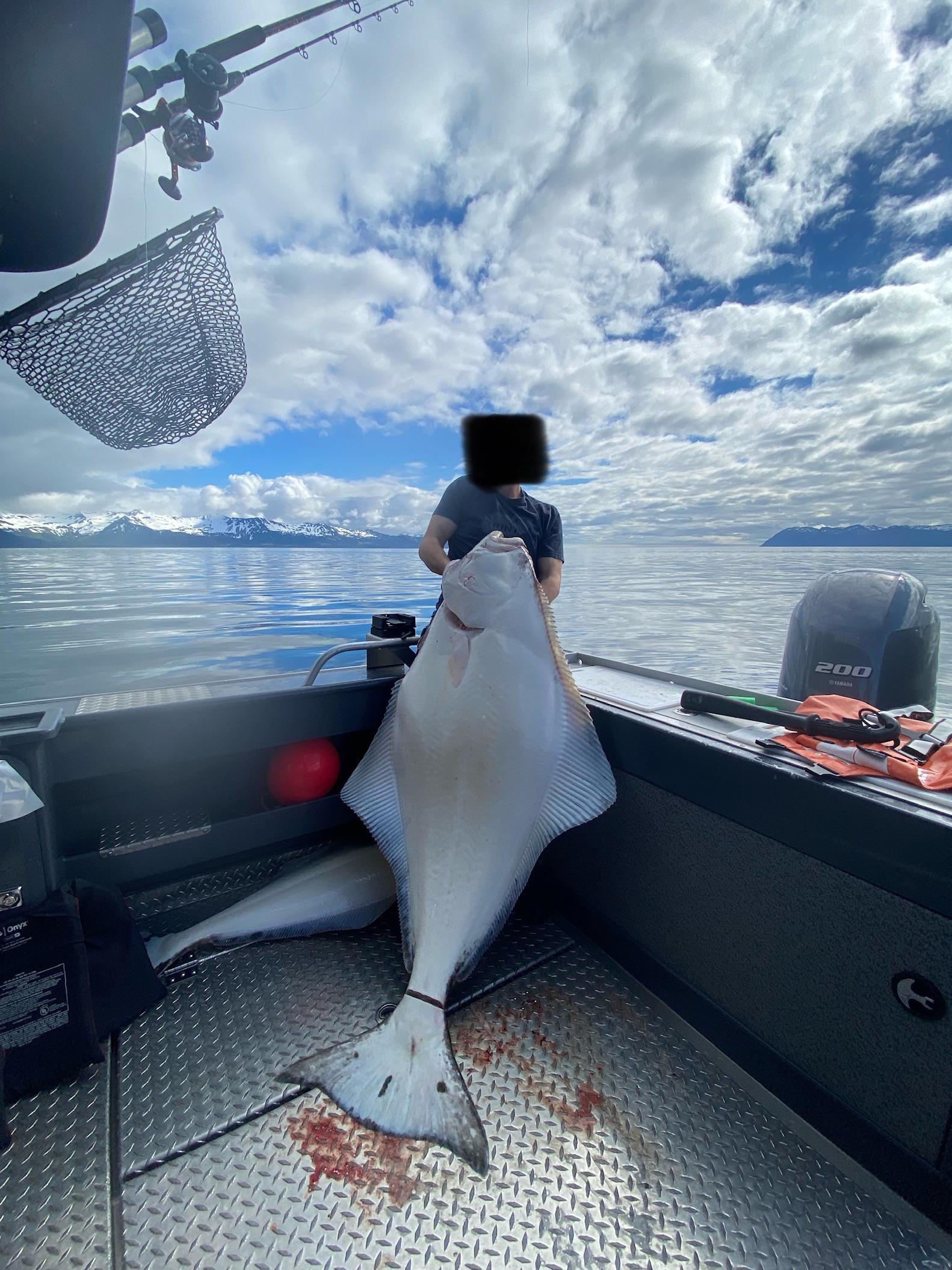 My son with a 140 lb Halibut in Prince William Sound. Kodiak Custom Jig
