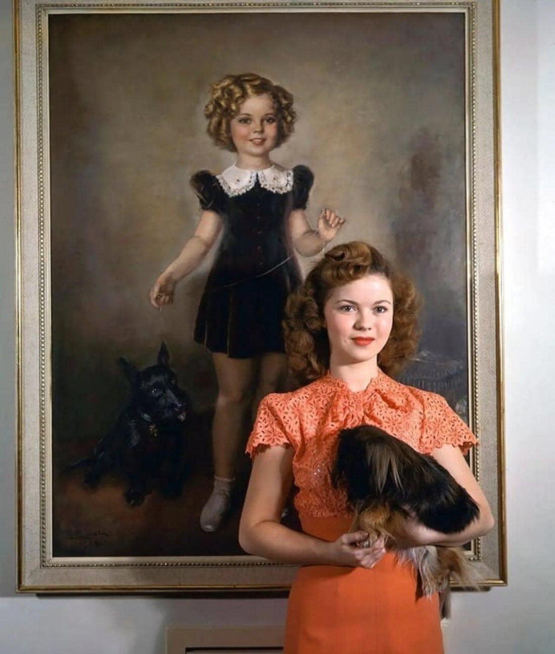Shirley Temple posing by a painting of herself as a young child, 1945 r/BeAmazed
