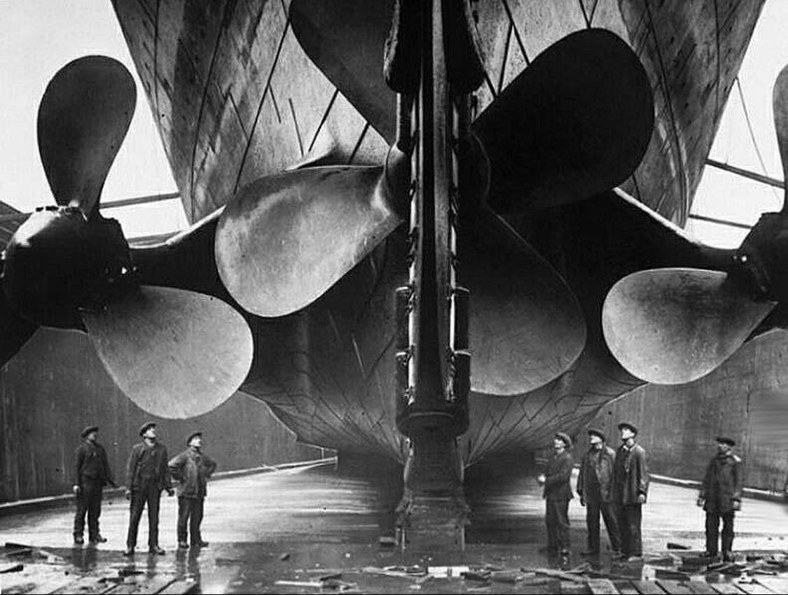 Harland and Wolff workers standing under titanic’s propellers c.(1912