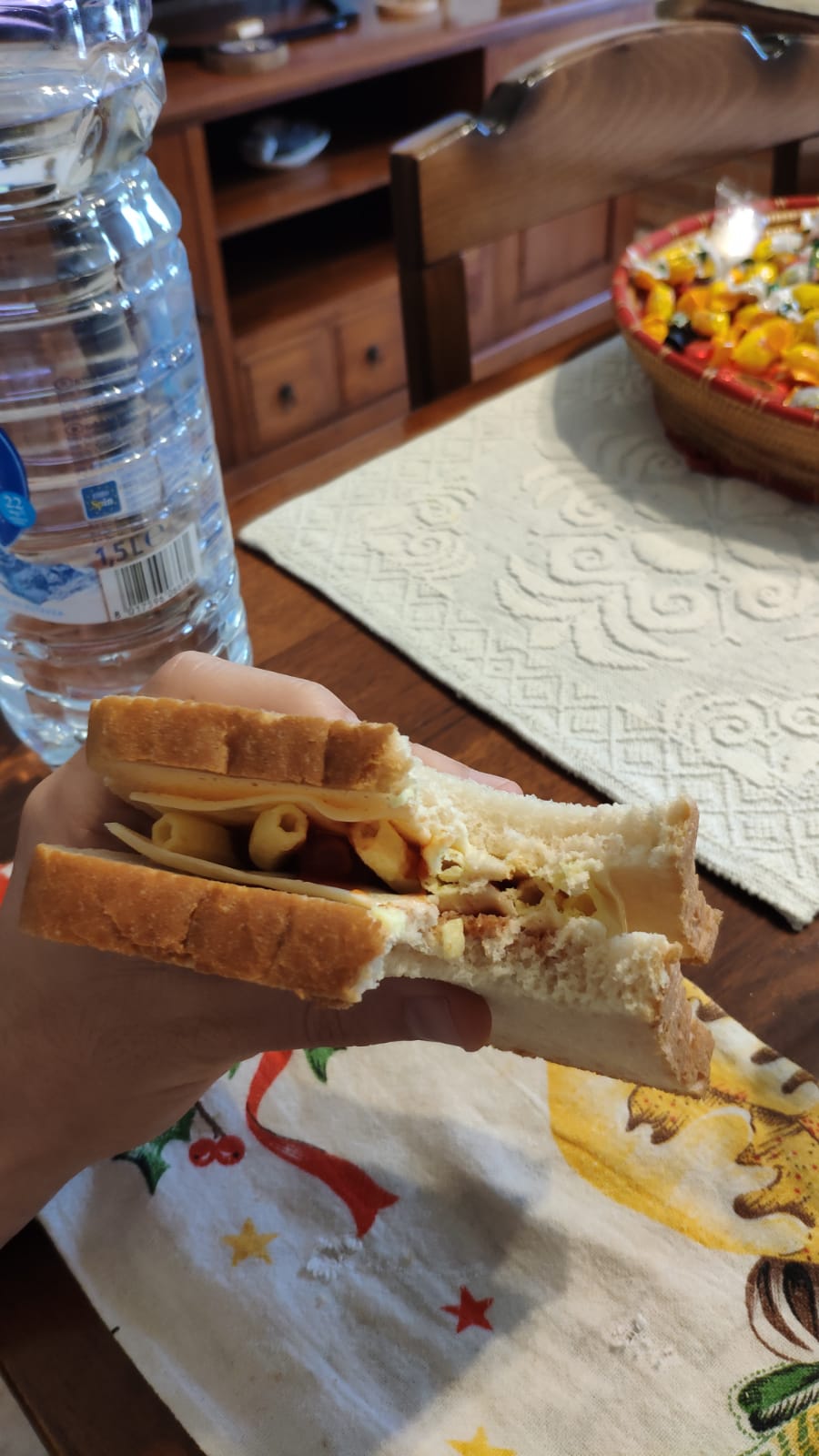 White bread, two slices of processed cheese, ketchup and chips for