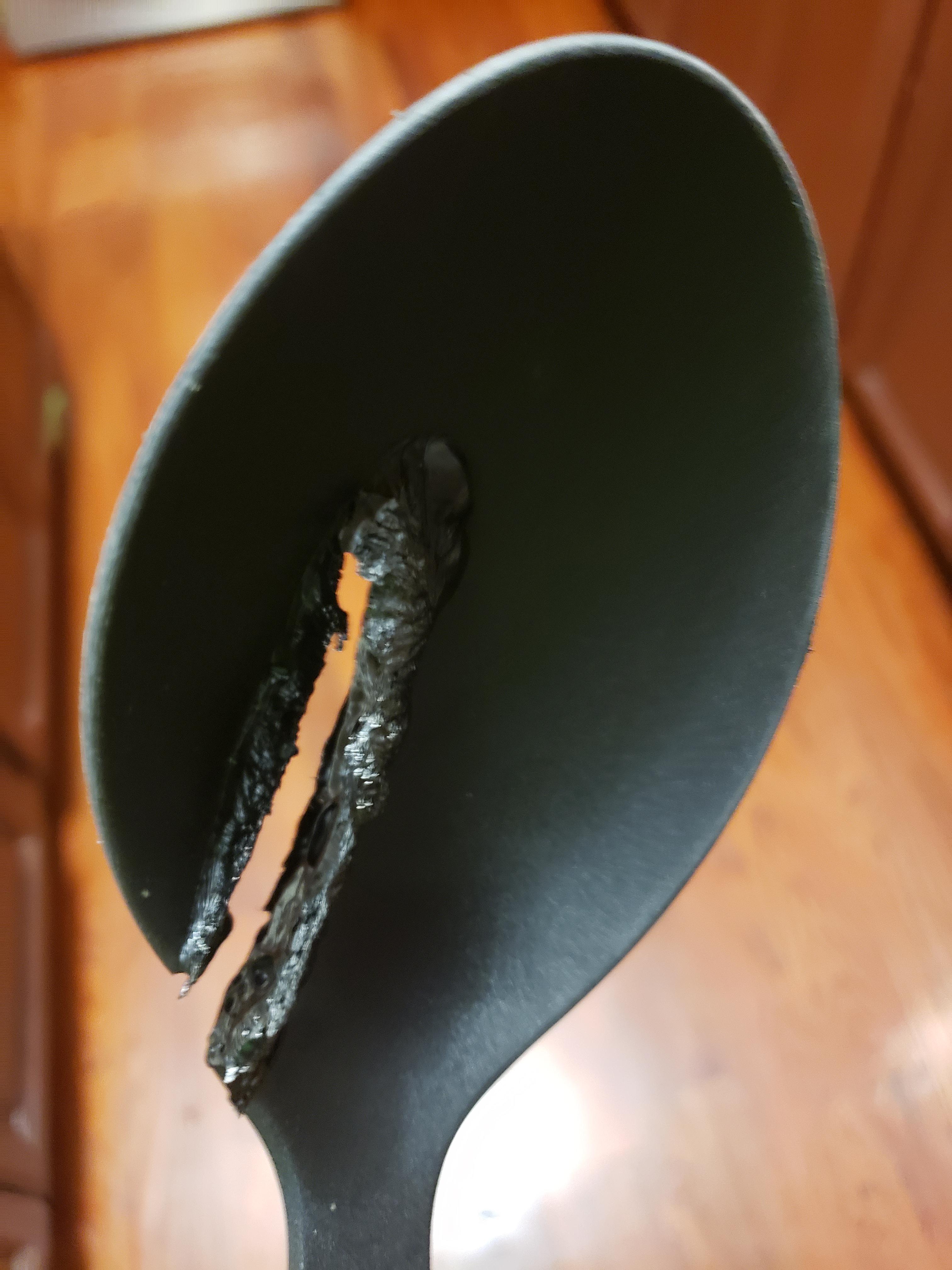 Plastic spoon fell on the heating element of the dishwasher while it