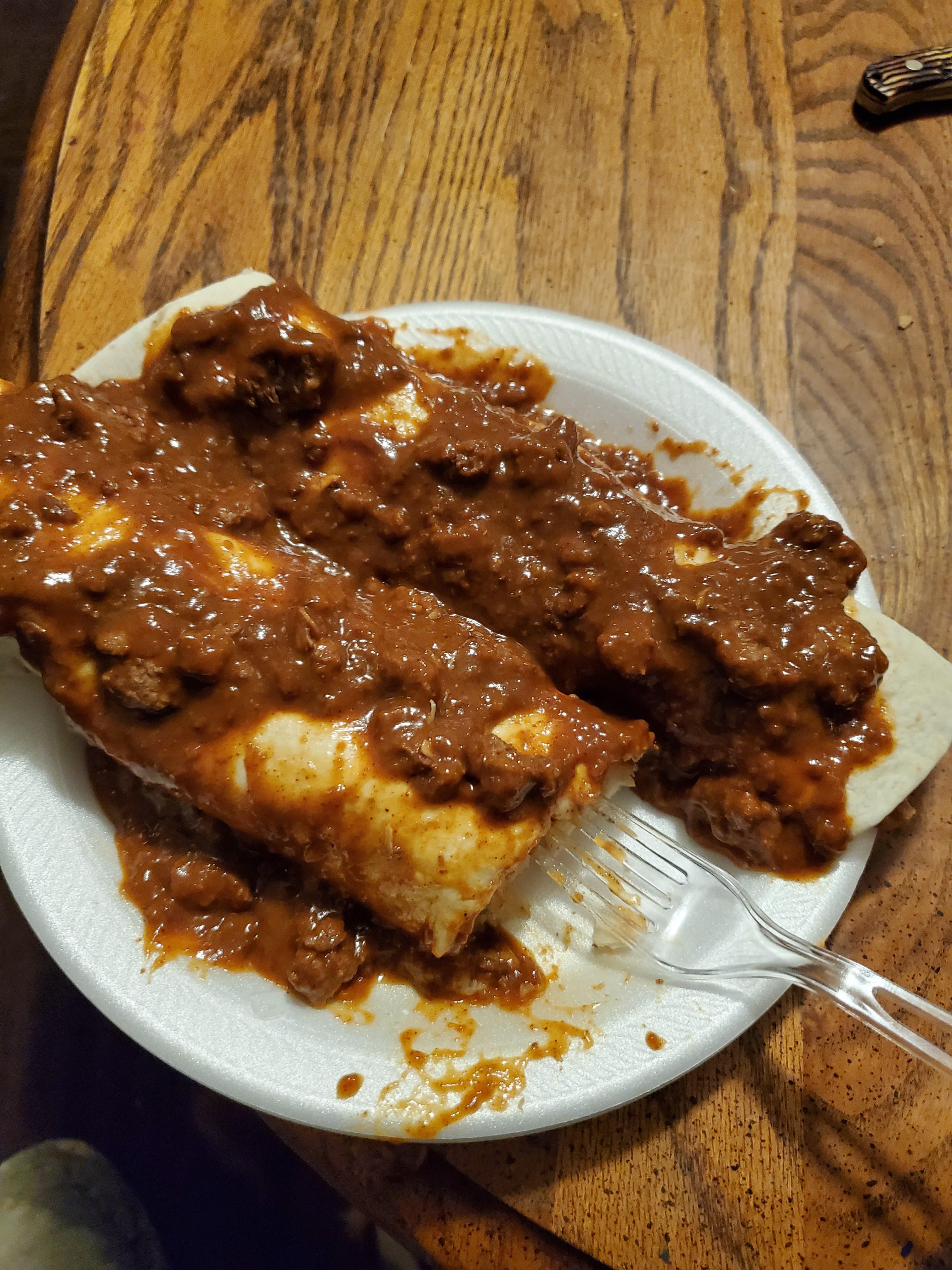 Microwaved taquitos wrapped in a tortilla and covered in chili r