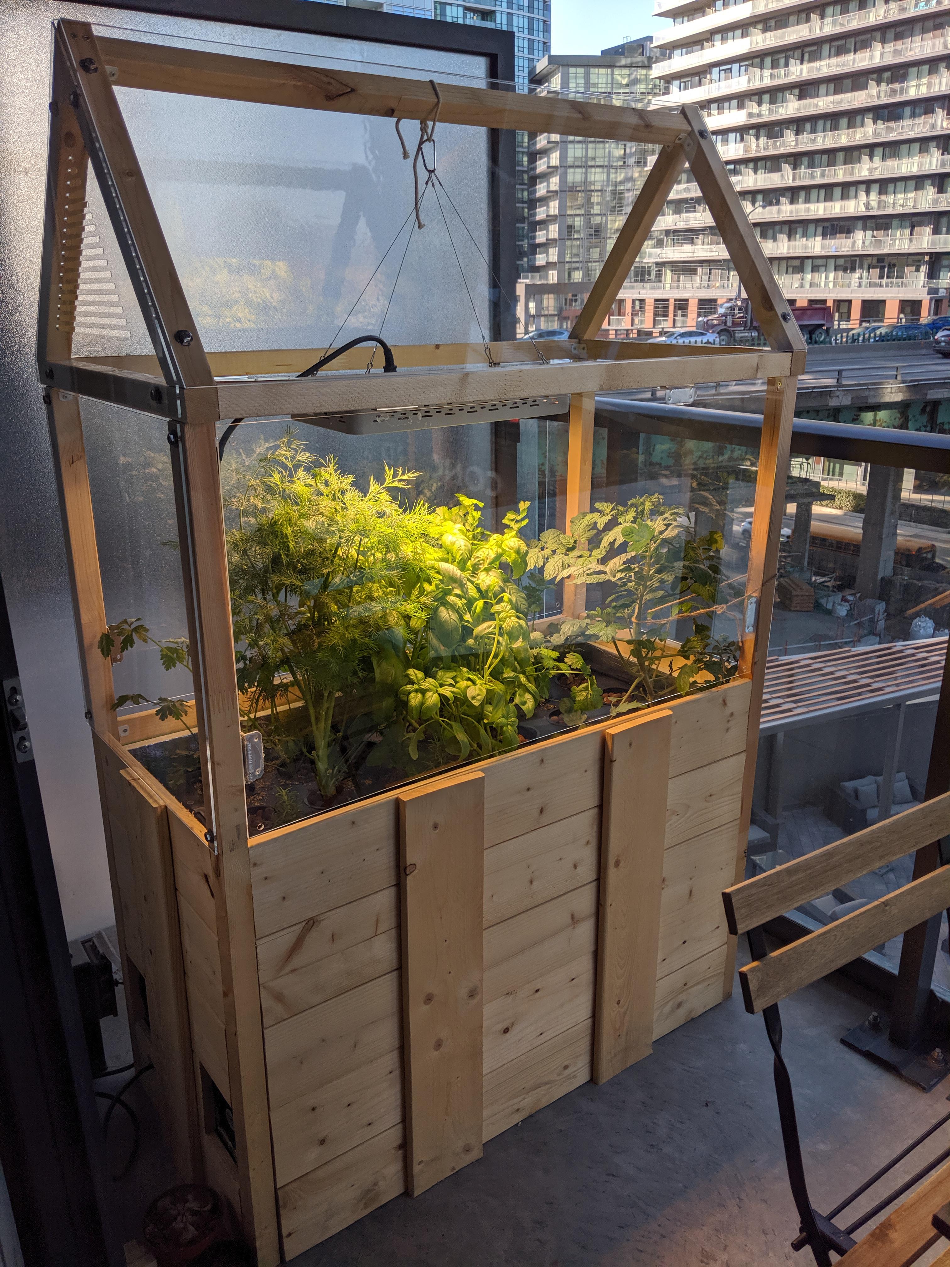 Finally finished building my mini balcony greenhouse (flood and drain