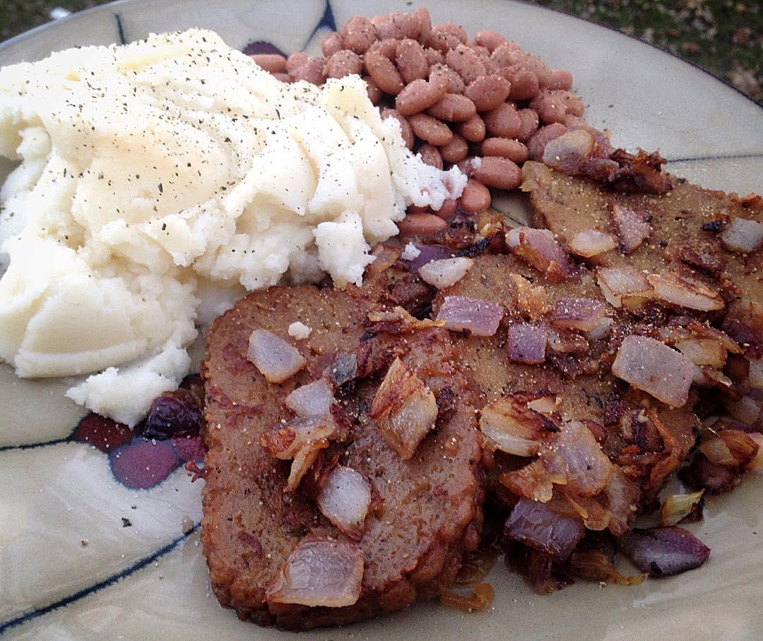 Field Roast's Celebration Roast slices fried with onions, mashed
