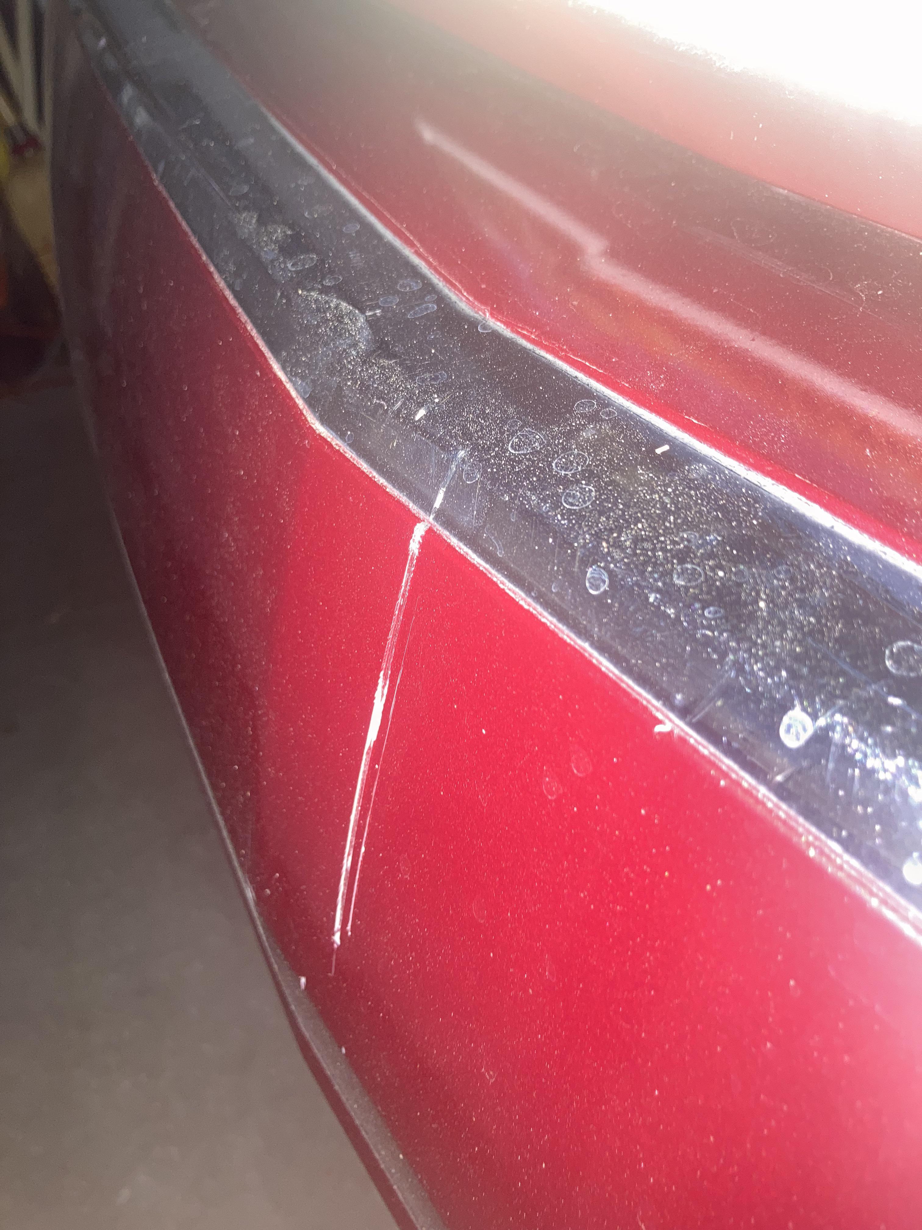 Garage door scratched the rear of my car. At most a 1/16” deep. Is